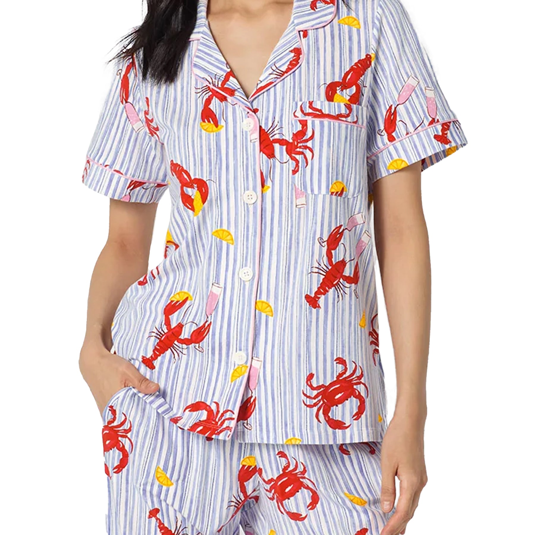 Detail of a blue striped pyjama set featuring red lobster print, yellow lemon accents, pink piping, and soft relaxed fabric.