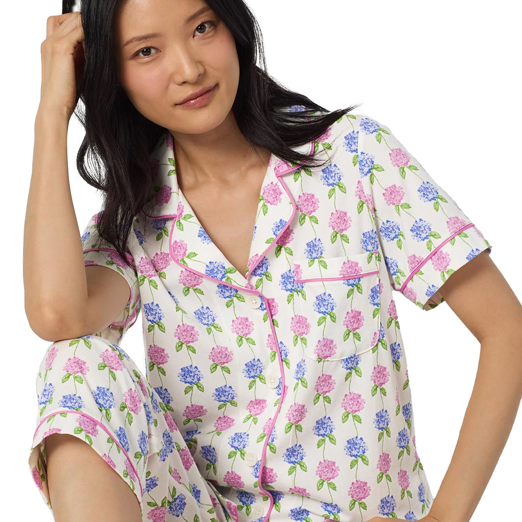 Close-up of a white floral pyjama top with pink piping, button-front closure, and delicate pink and blue hydrangea print.