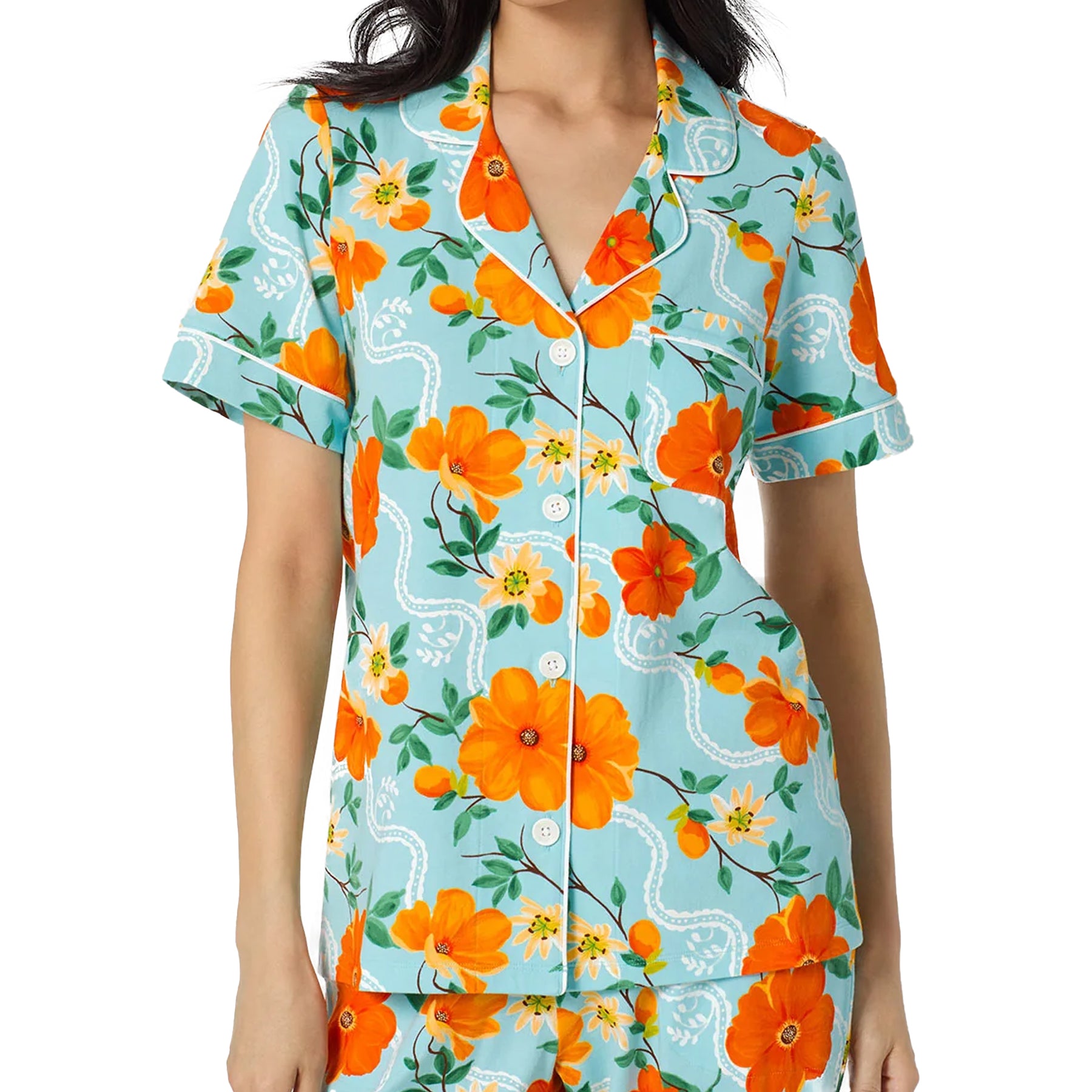 Close-up of Bed Head pajama set featuring vivid orange floral print on aqua blue sleepwear fabric.