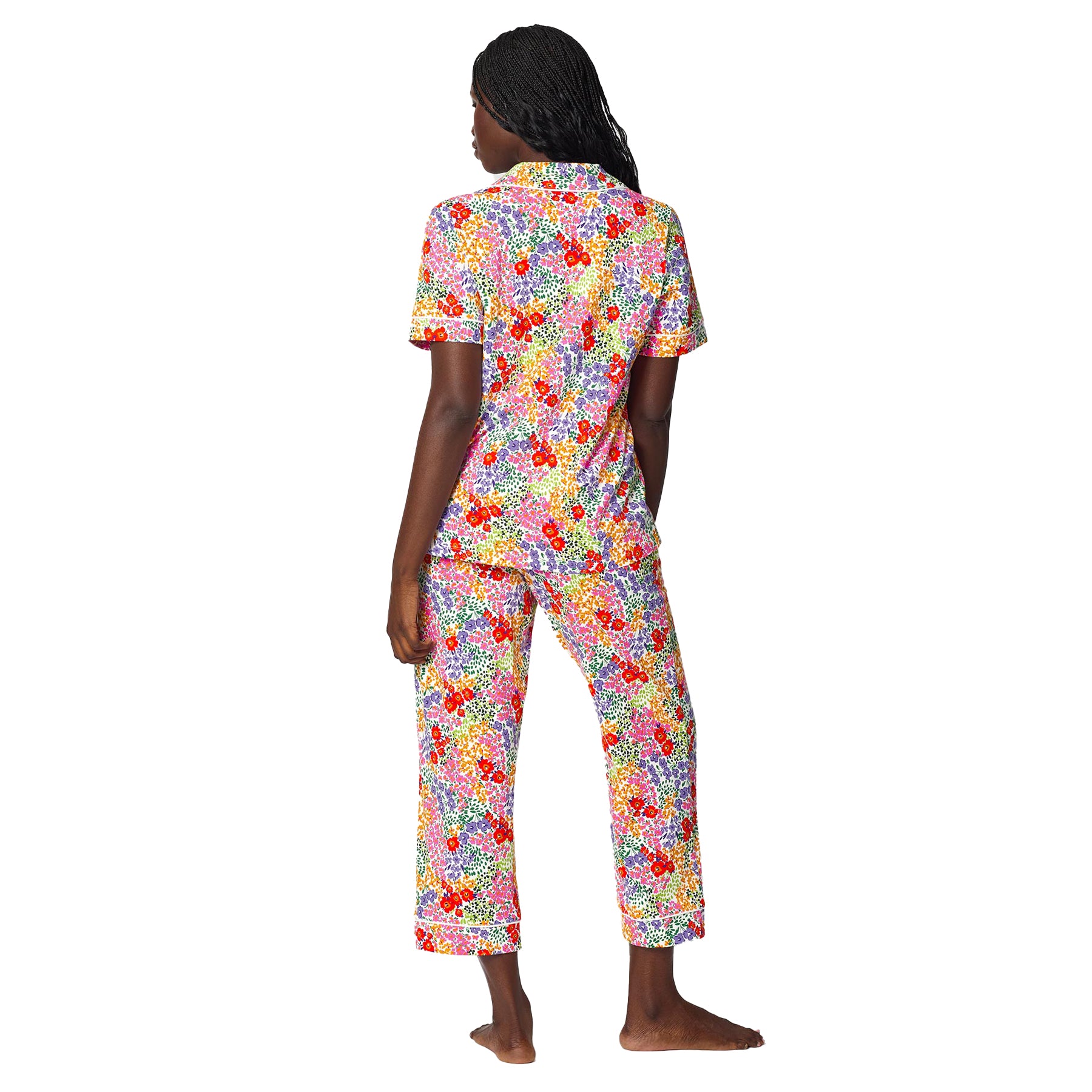 Back view of women’s colourful floral pajama set with short sleeve button-front top and cropped pants in vibrant red, purple, yellow and green botanical print.