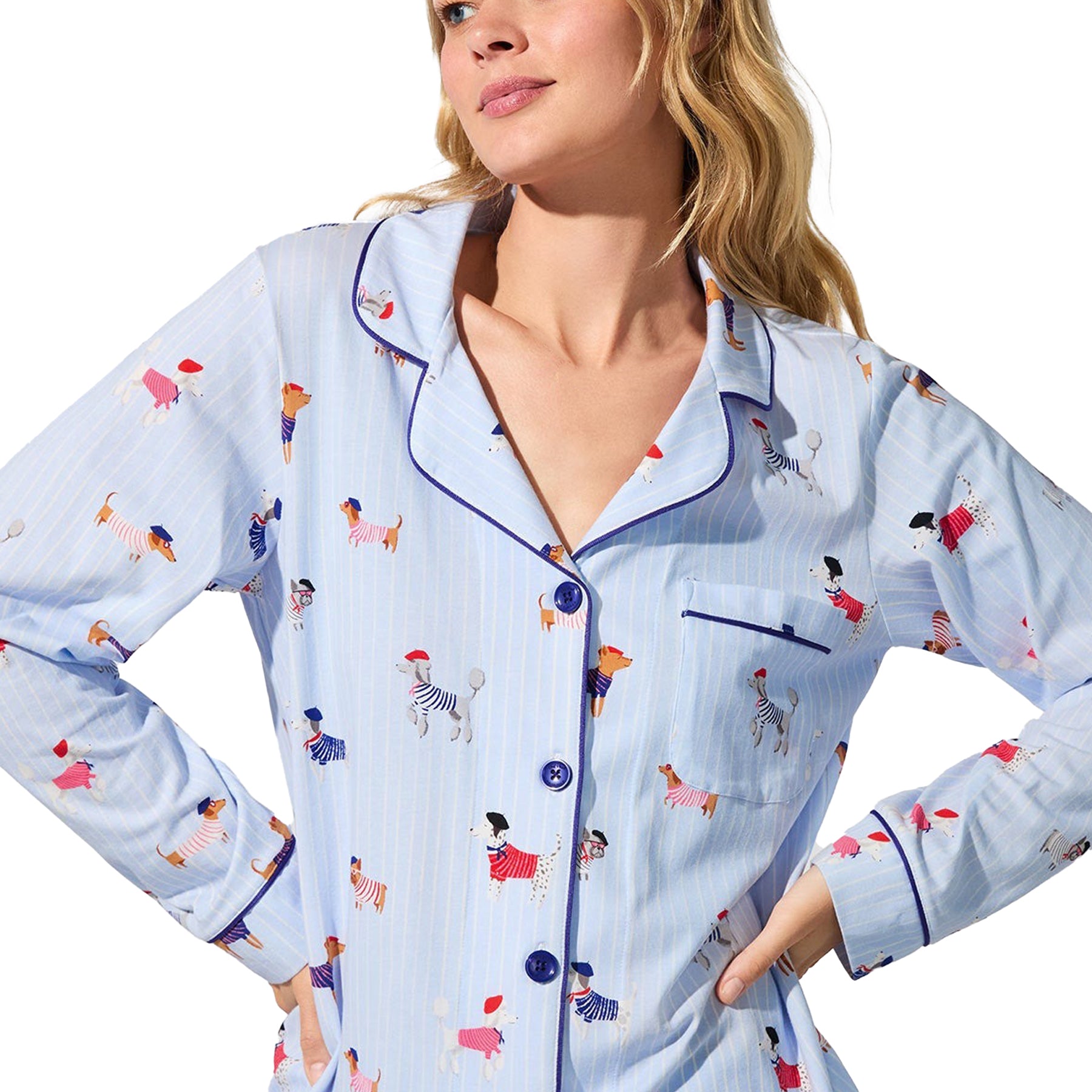 Close-up of light blue button-front pyjama top with dog print and navy piping