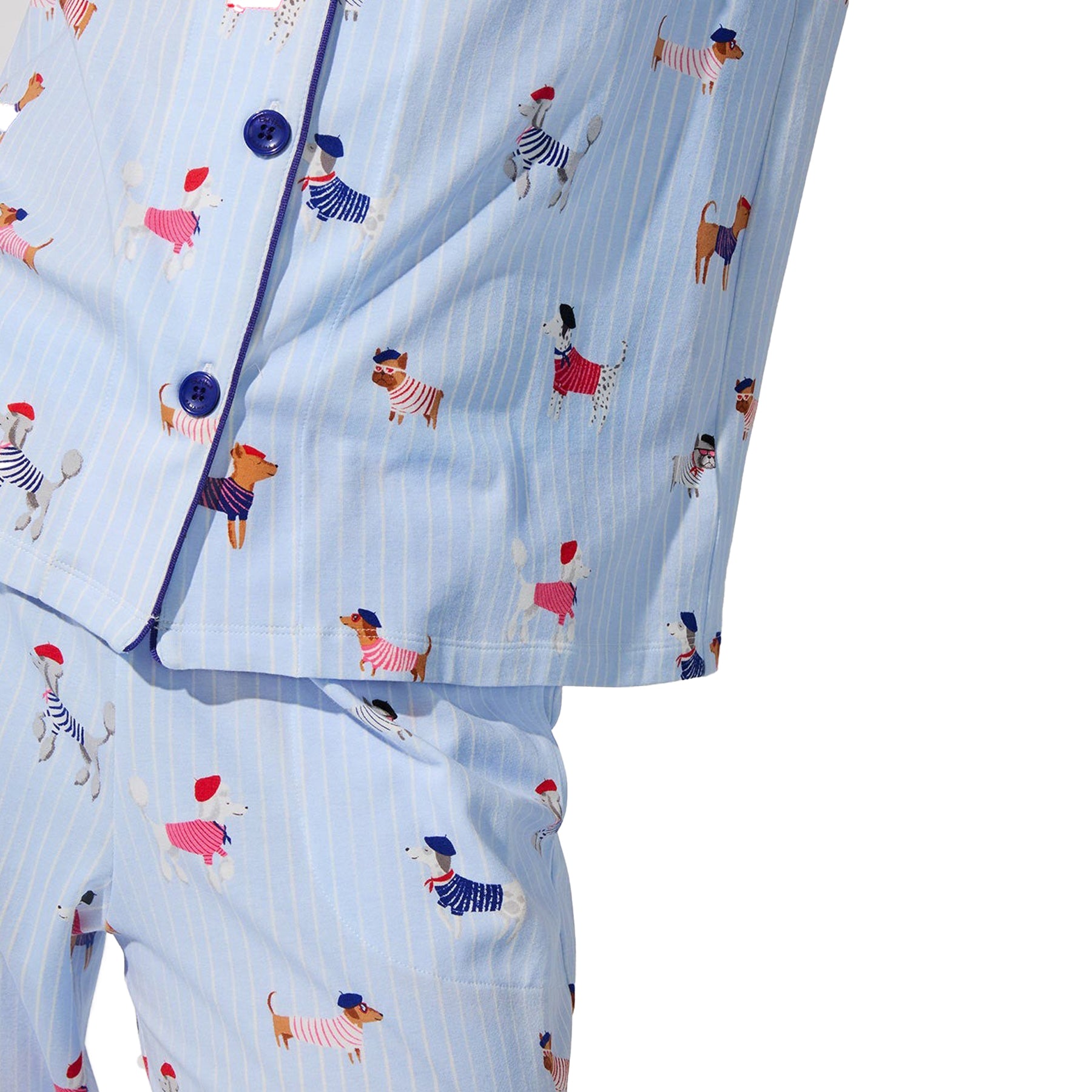 Detail of light blue dog-print pyjama fabric with navy piping on hem