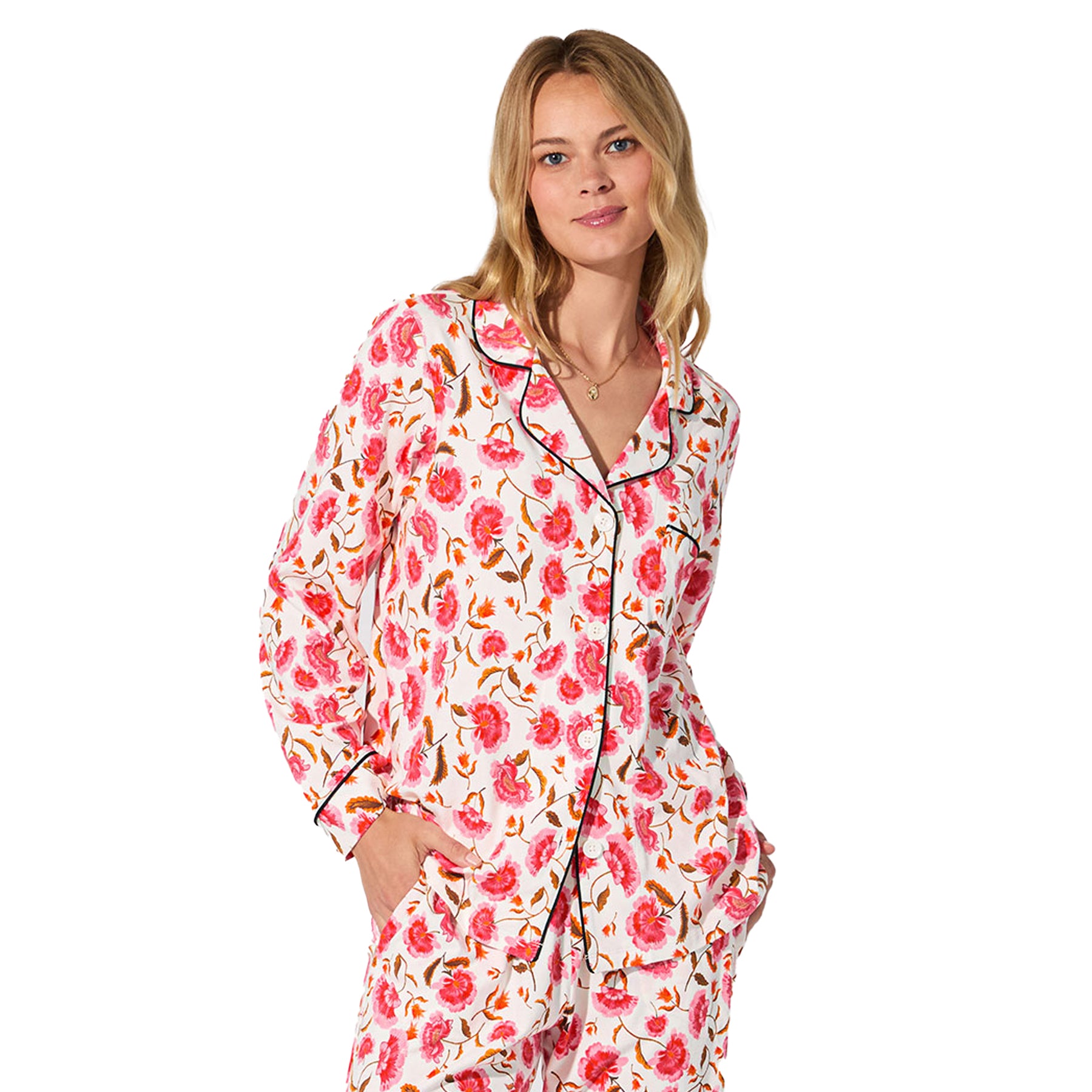 Close-up of white floral pyjama shirt with black piping and bold pink flower print.