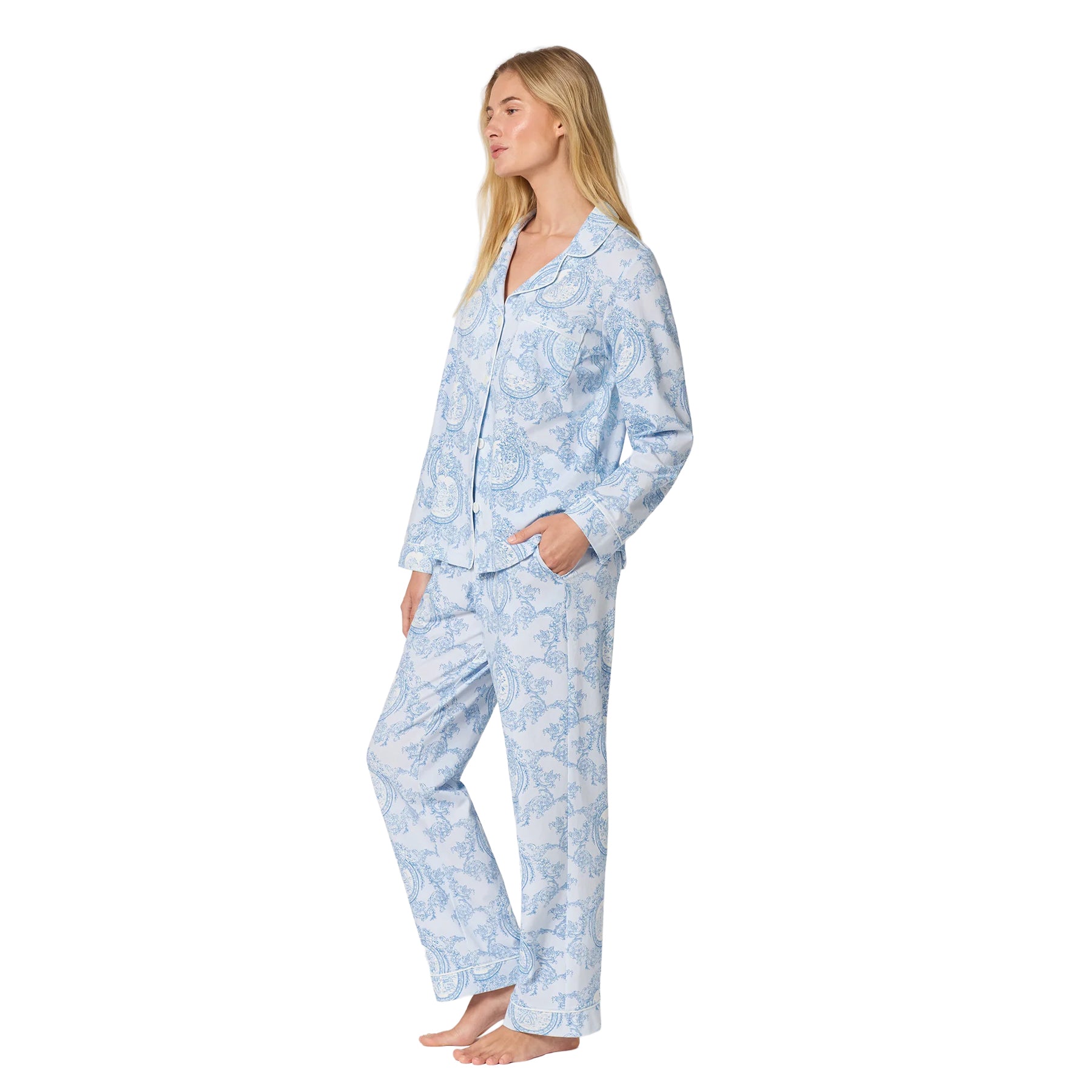 Side view of a light blue toile-print pajama set with long sleeves, button-front top, relaxed pants and side pockets.