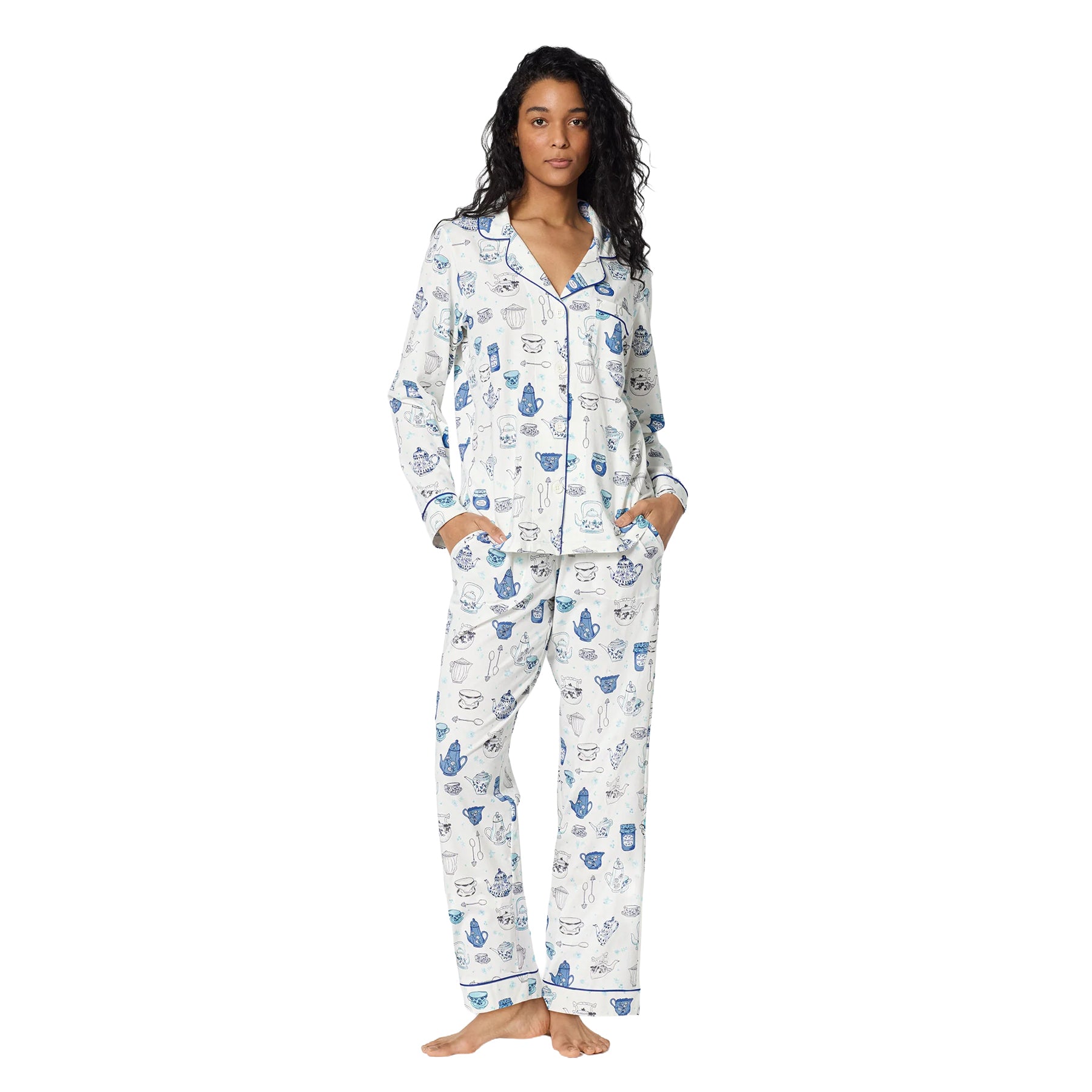 Model wearing a white and blue BedHead pajama set featuring a playful teapot, teacup and kitchen-inspired print.