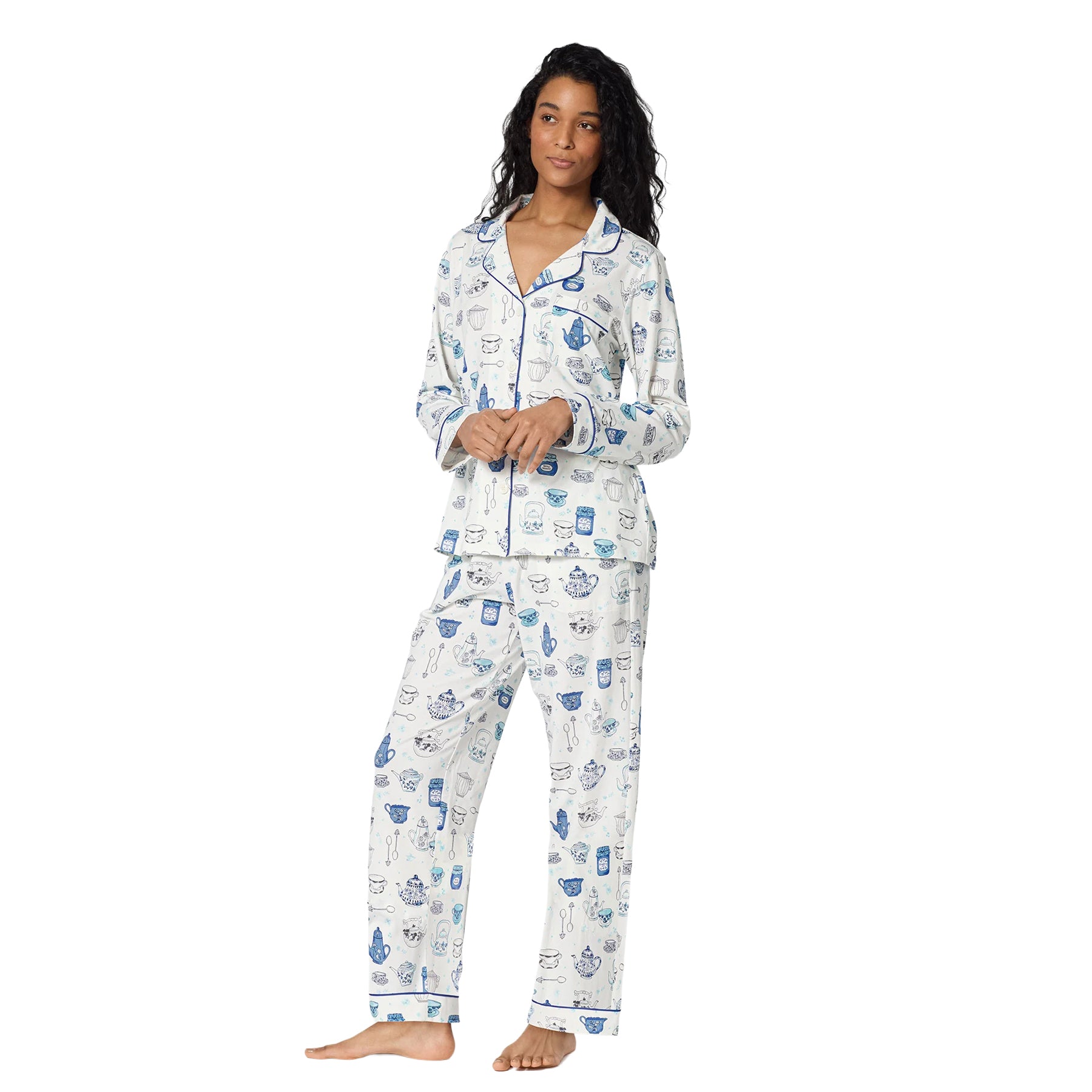 Model wearing BedHead long-sleeve pajamas with an all-over blue tea print, button-front top and matching pants.