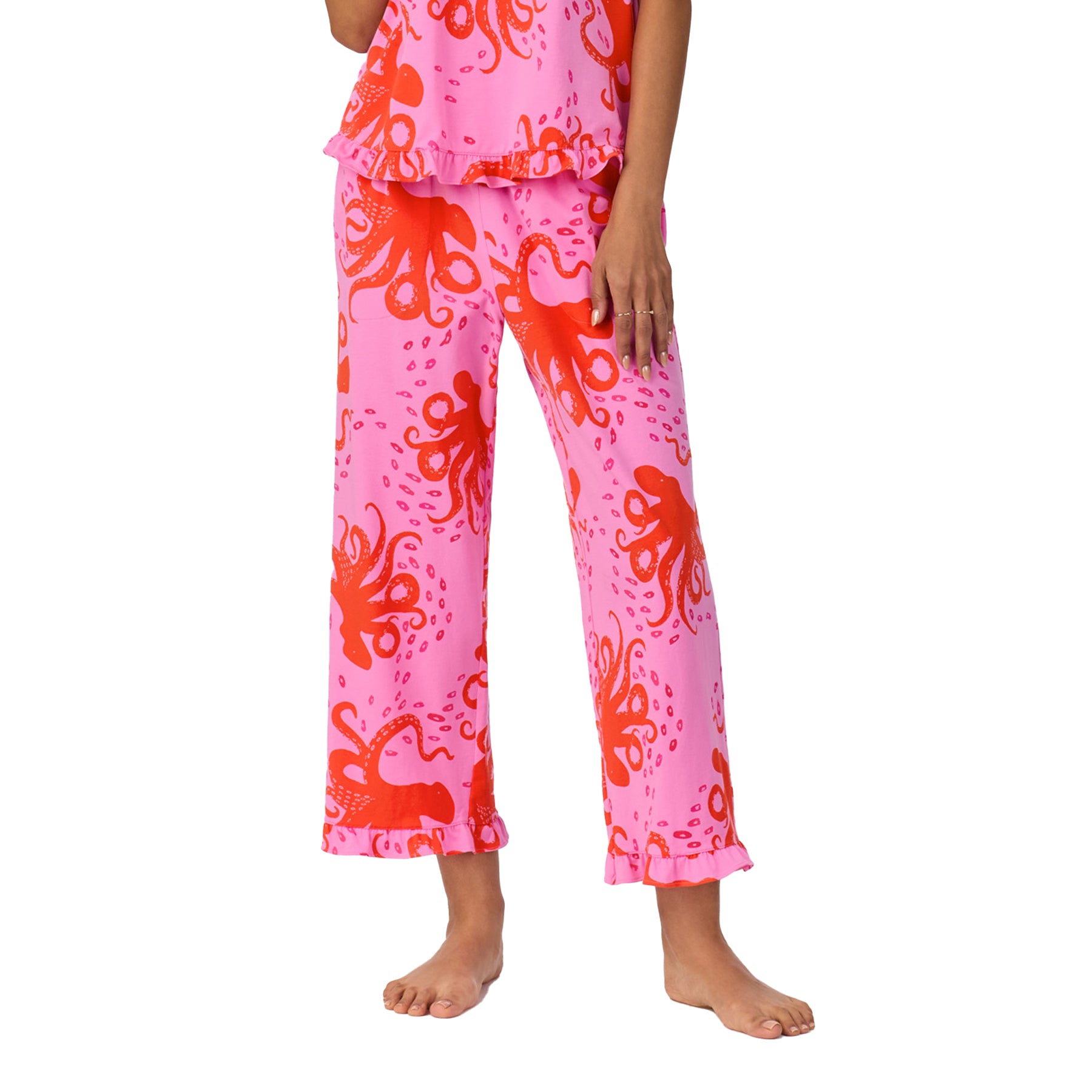 Close-up of pajama pants showcasing the vibrant coral octopus pattern and ruffled hem detail