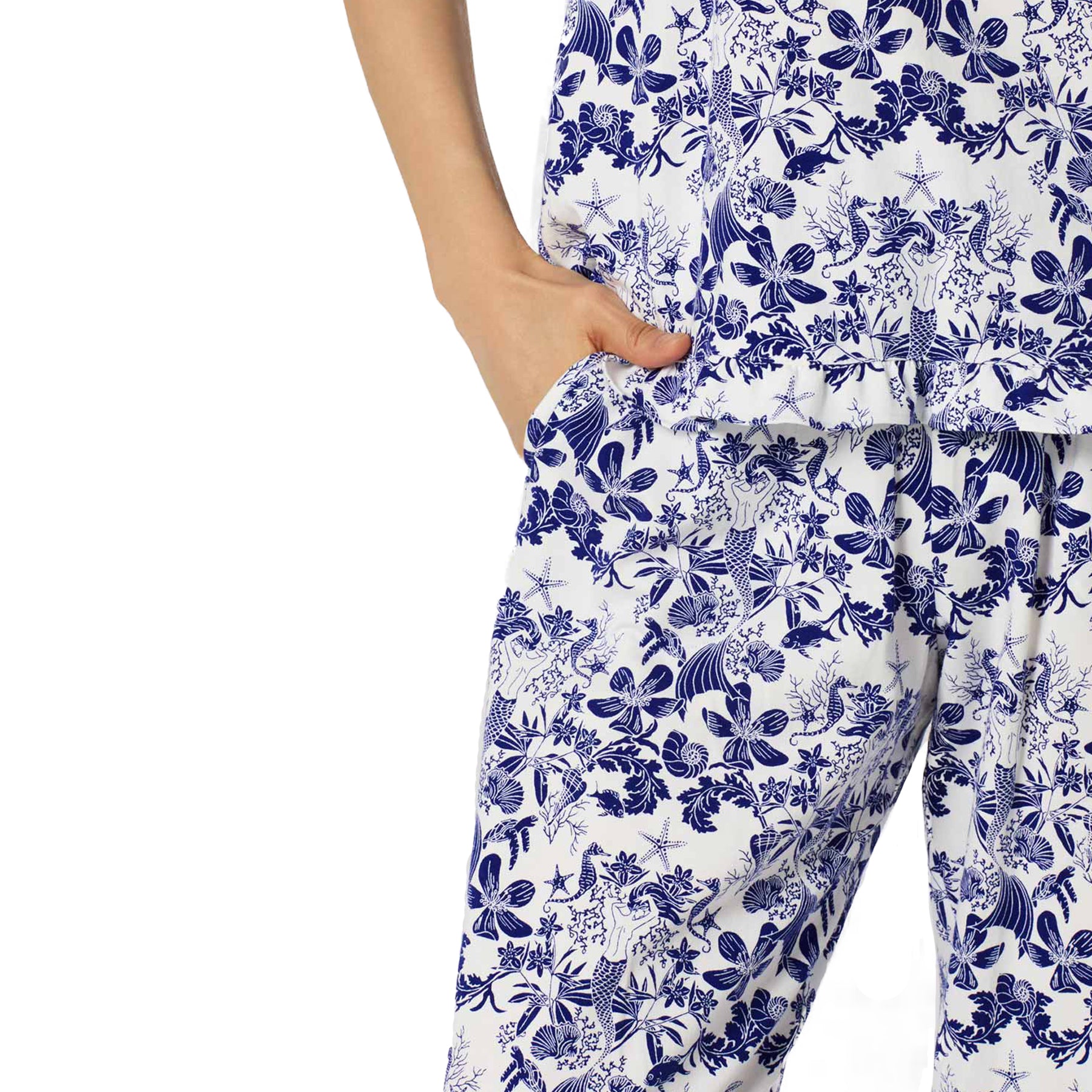 Close-up of Bedhead pajama pants featuring blue undersea floral print with mermaids, seashells, and starfish details.
