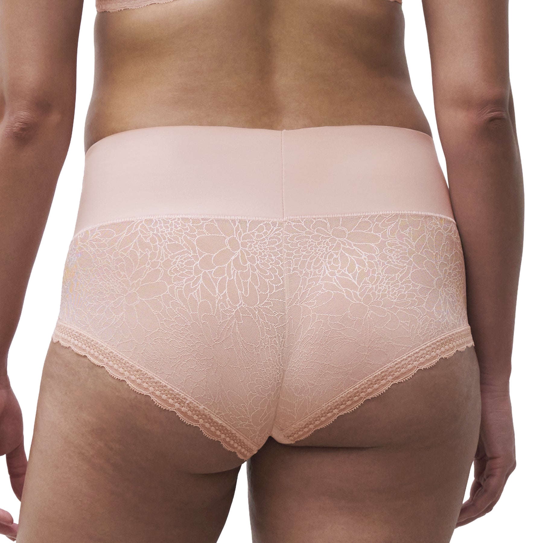 Chantelle high-waist smoothing shorty in soft blush with seamless front panel and delicate floral lace sides, back view.