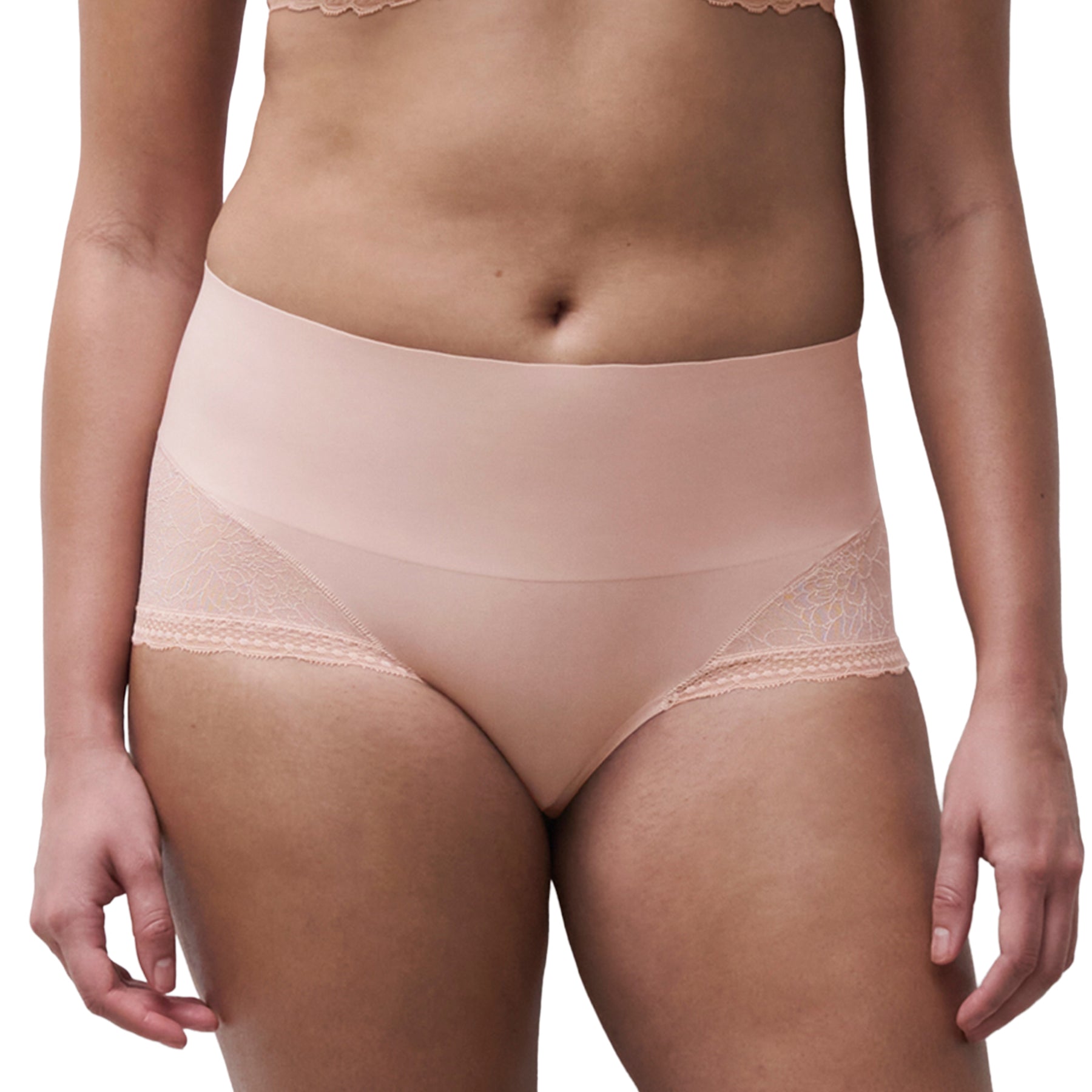 Model wearing Chantelle high-waist smoothing shorty in soft blush with seamless tummy-smoothing front and floral lace side panels, front view.