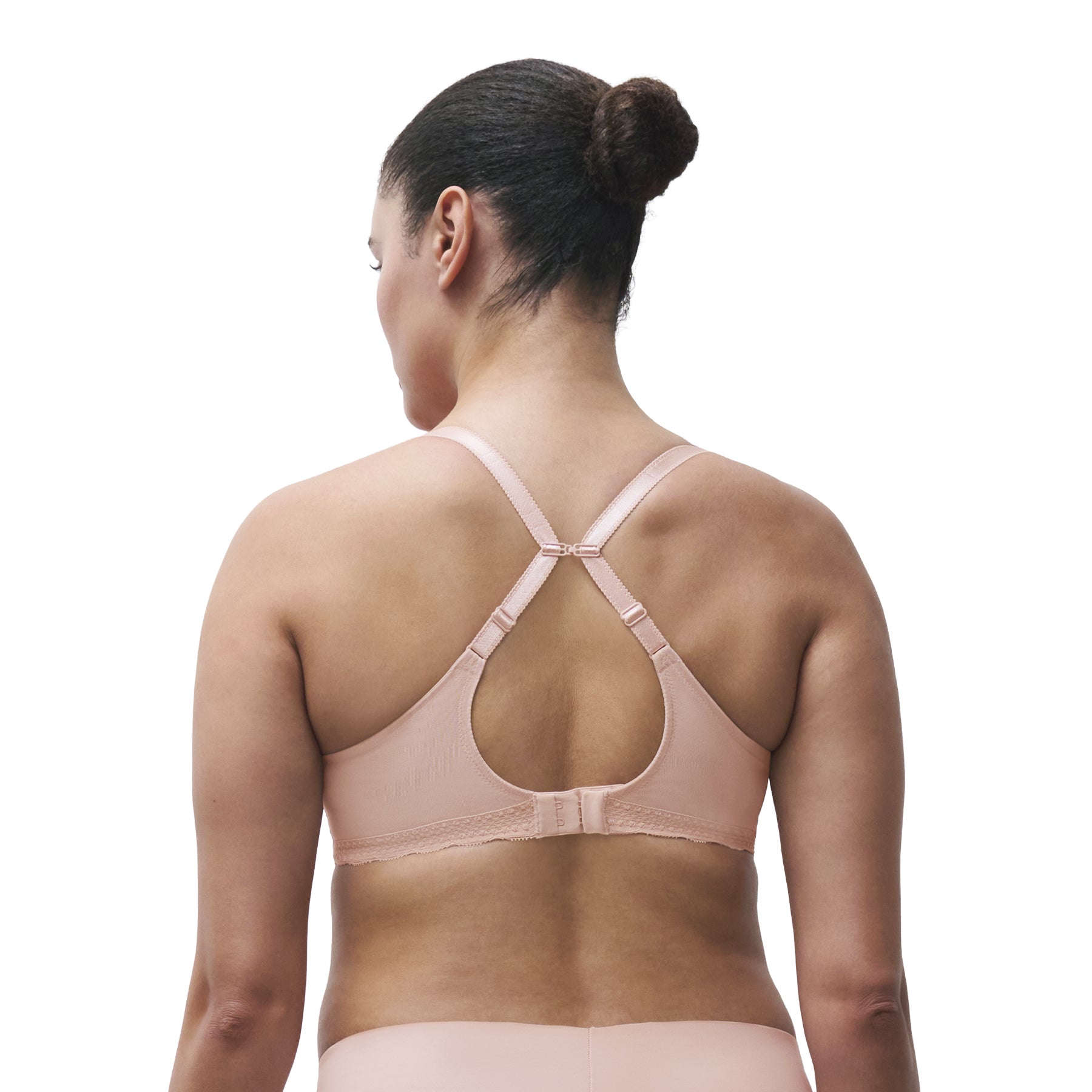 Back view of model wearing Chantelle blush pink lace full cup underwire bra with convertible racerback straps and supportive back band.