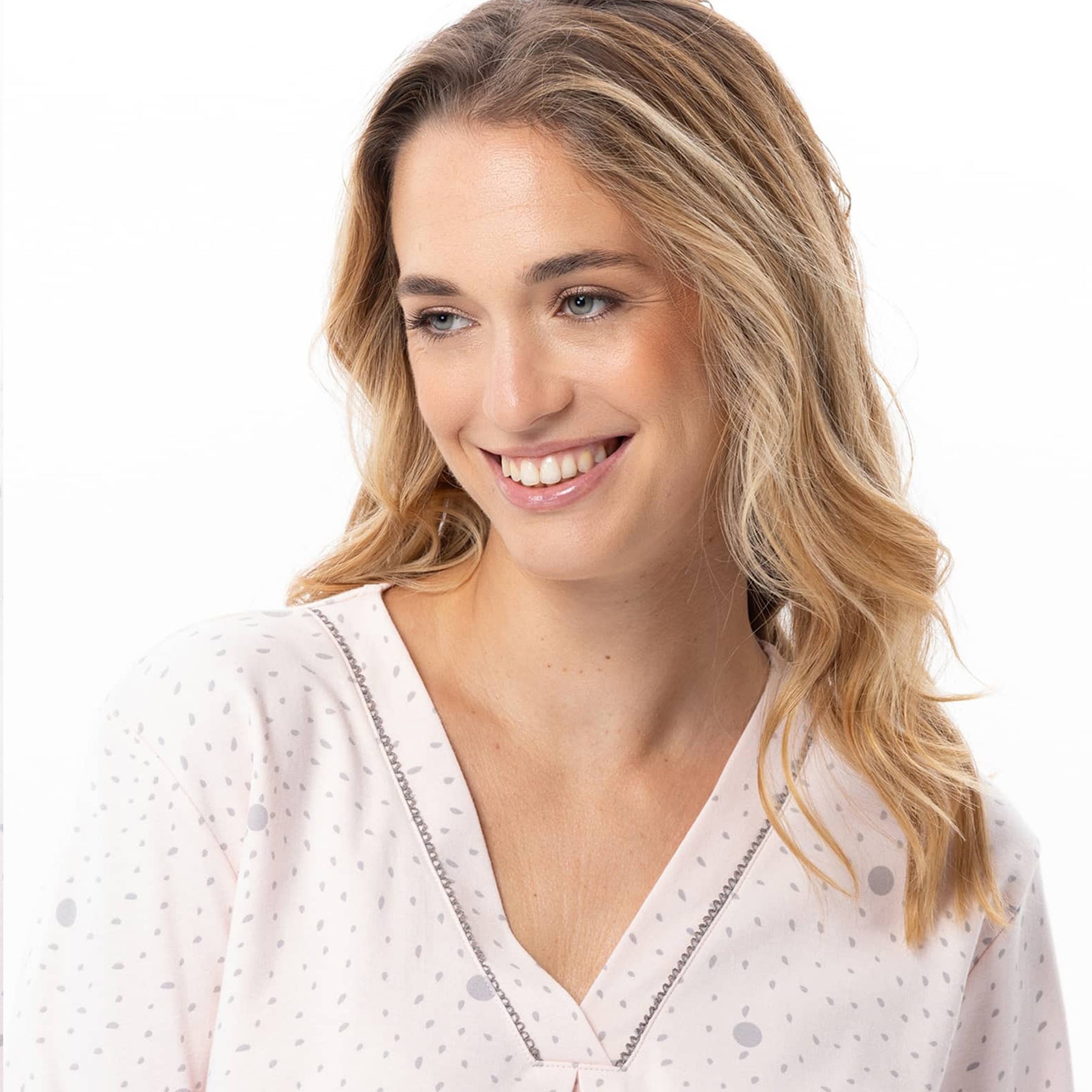 Woman wearing a white blouse with small patterns on a white background
