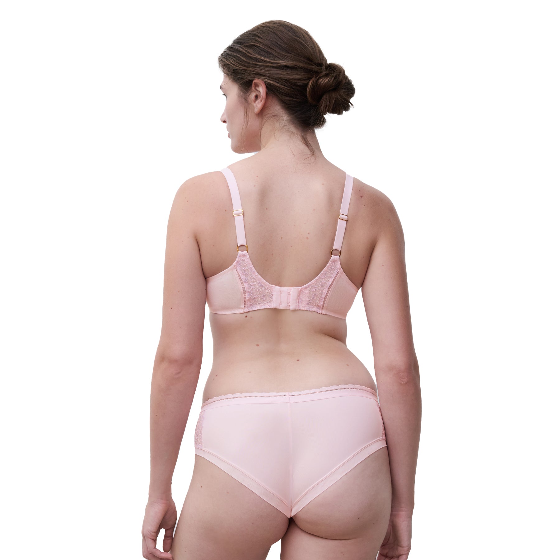 A model wearing a pink Chantelle bra on the white background., back view.