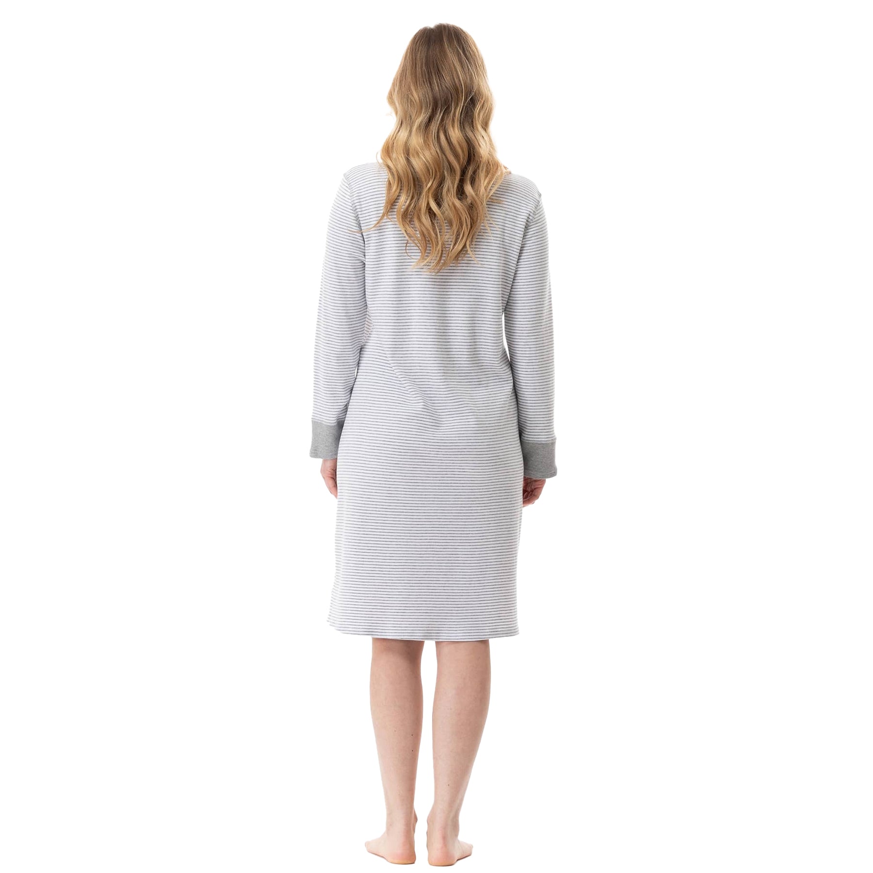 Woman wearing a gray striped dress against a white background