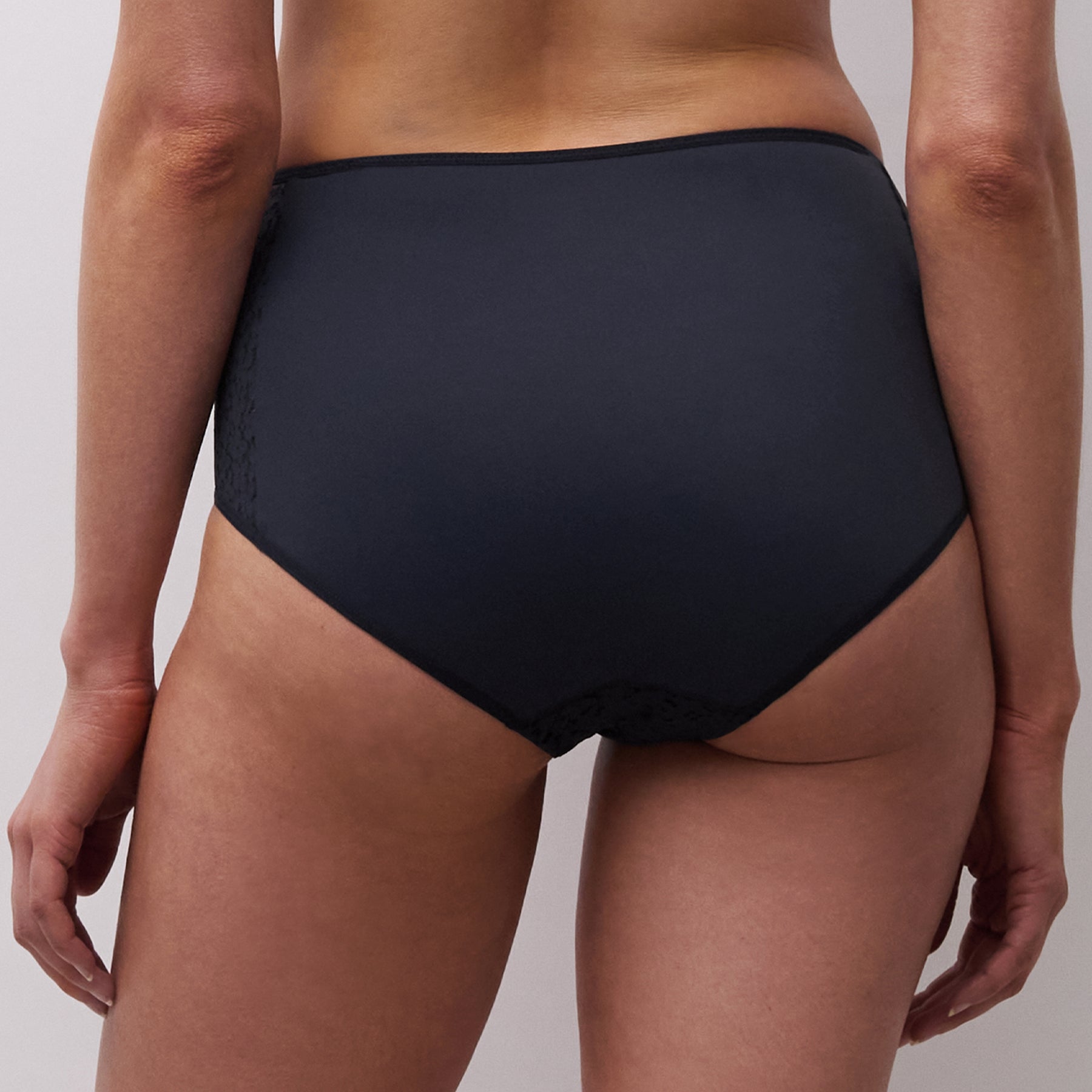 Back view of navy high-waisted brief on model with smooth rear coverage and soft stretch fit.