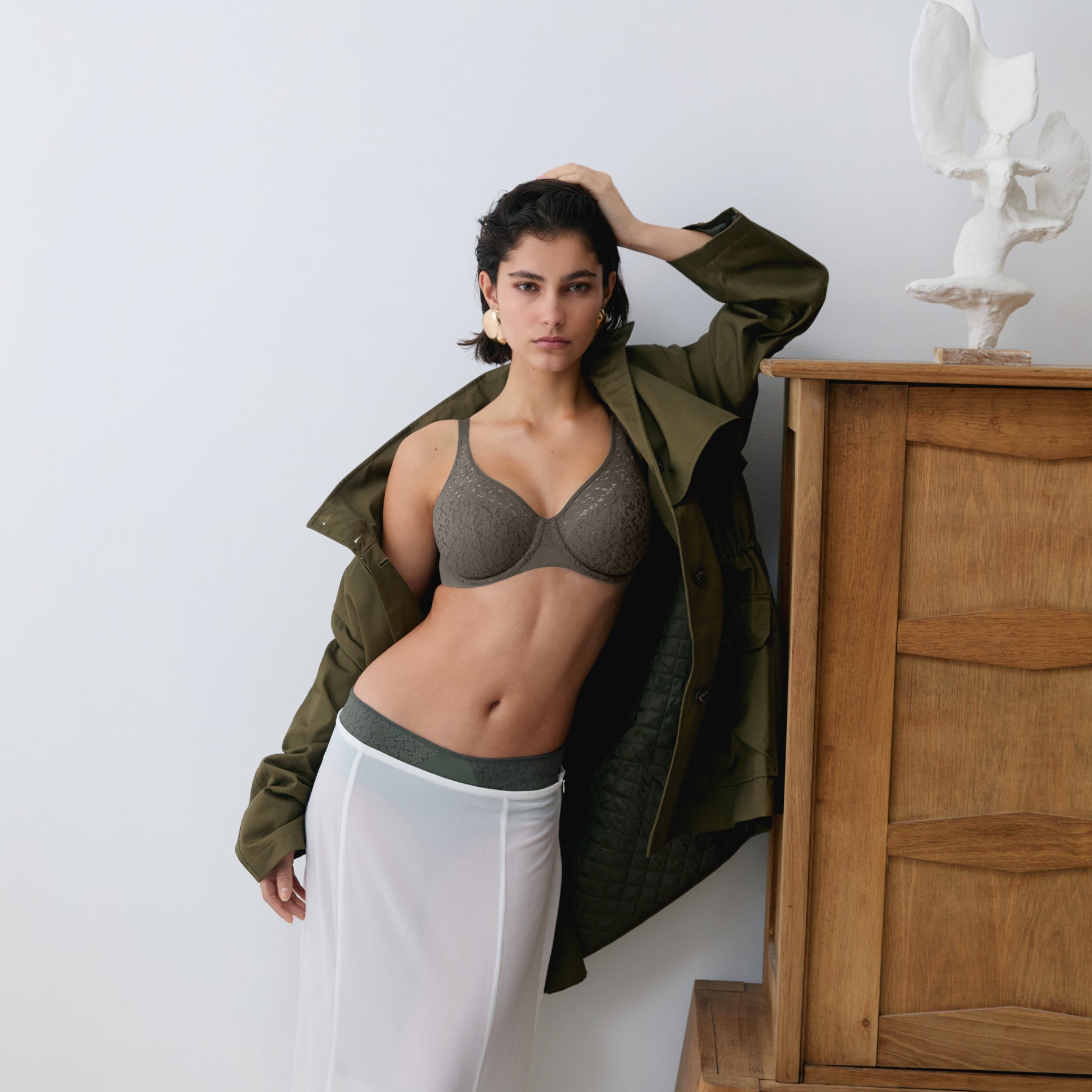 Full-length lifestyle image of the Chantelle Norah Full Cup Seamless Bra in Vert Argile with coordinating briefs, combining seamless comfort, floral lace, and contemporary style.