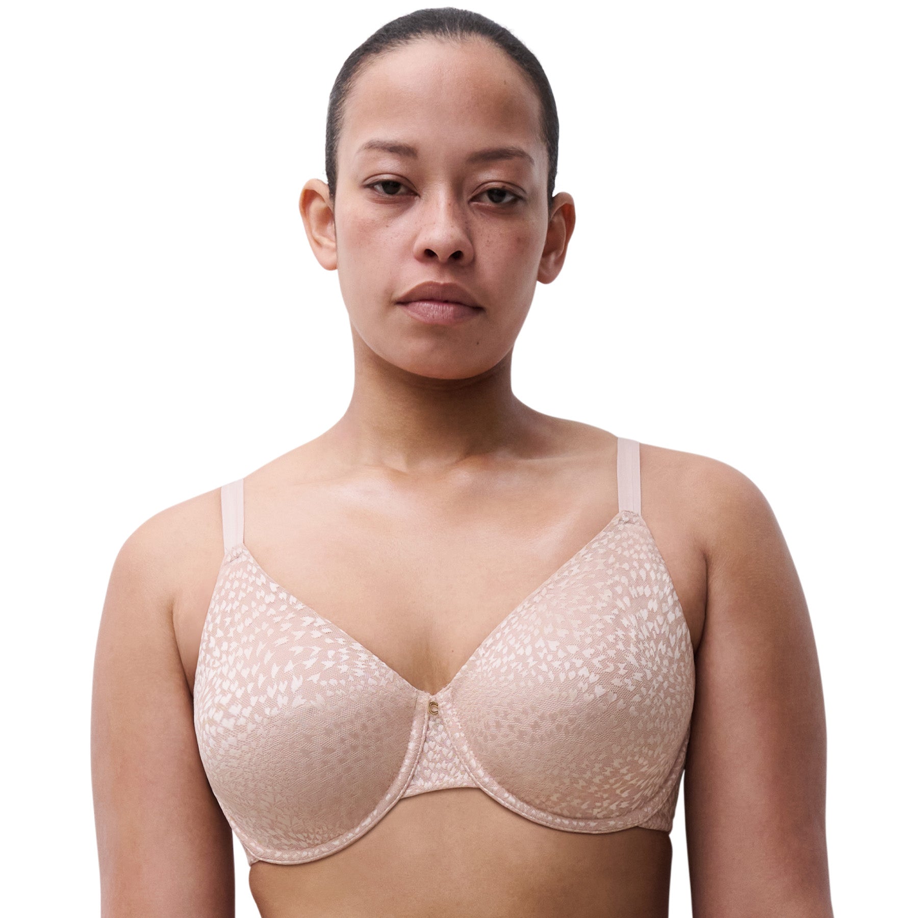 Woman wearing soft pink full coverage minimizer bra with subtle animal print design and smooth finish.