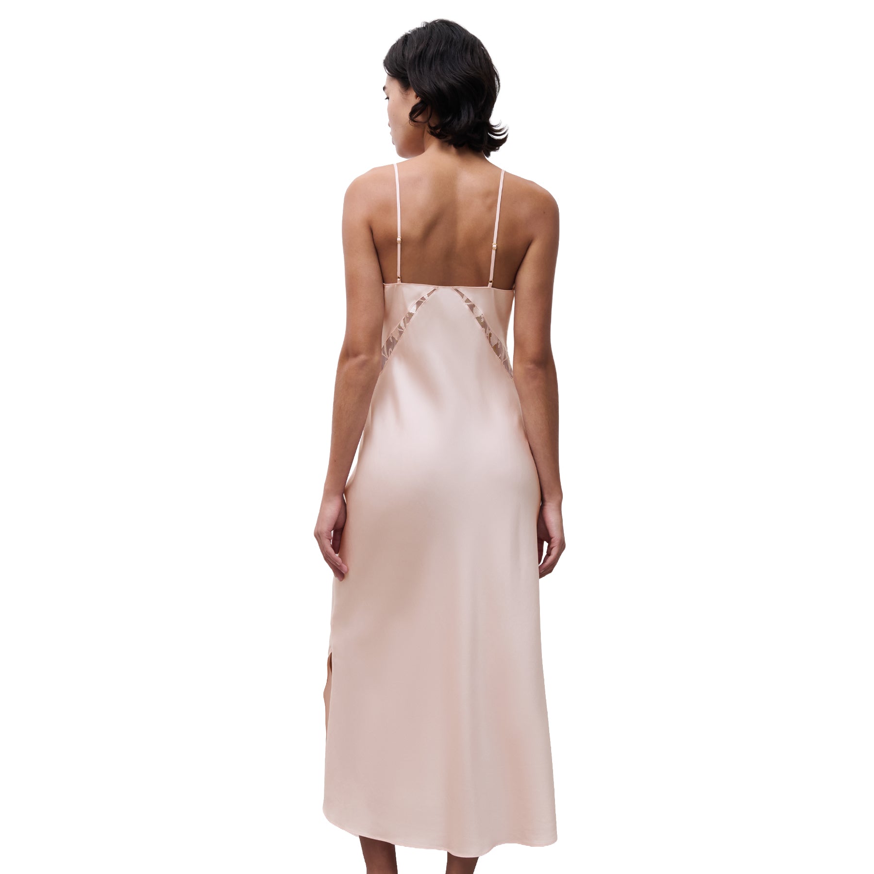 Back view of blush pink long slip dress with lace inset detail and adjustable straps, shown on model.