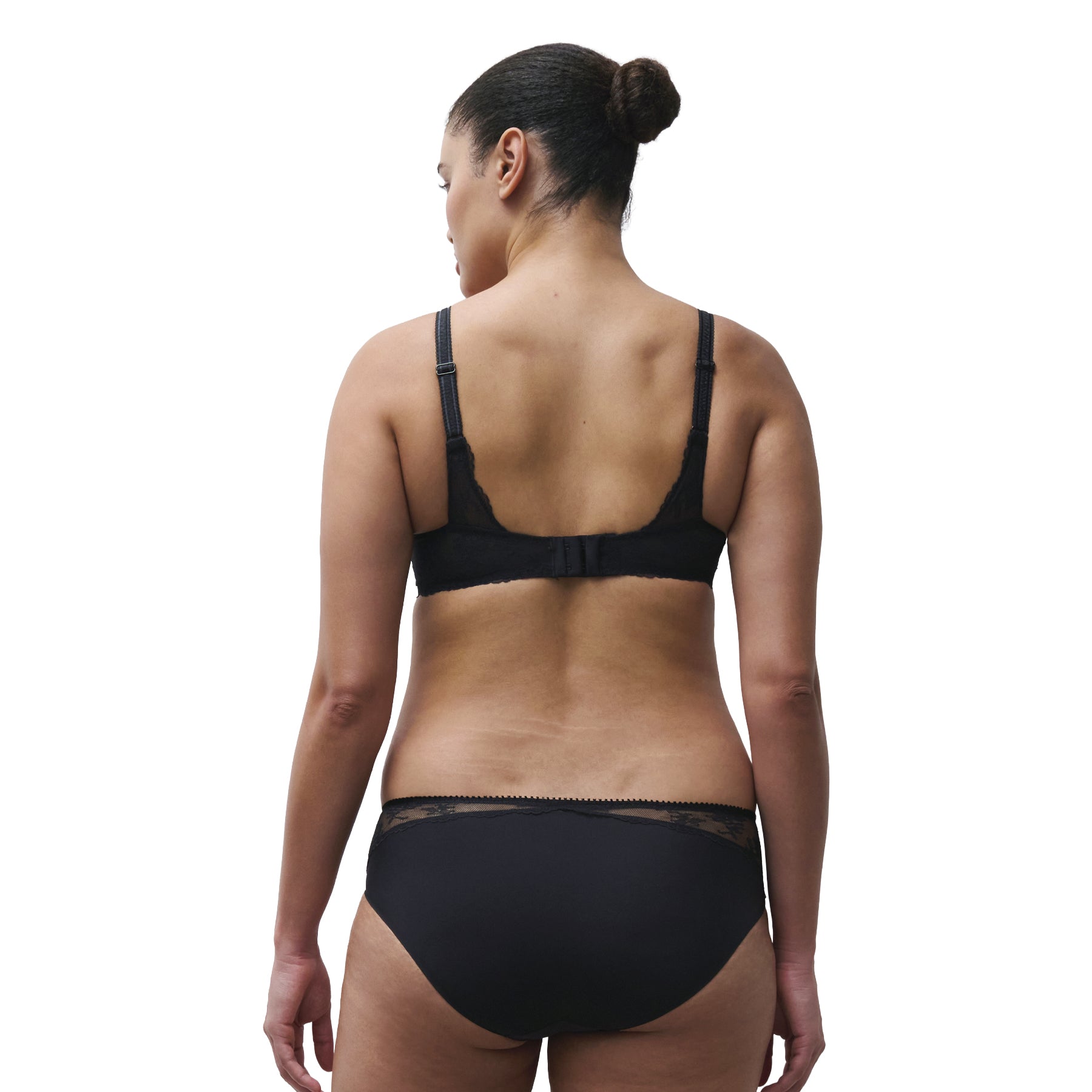 Model wearing a black lace underwire bra with adjustable straps and hook-and-eye back closure.