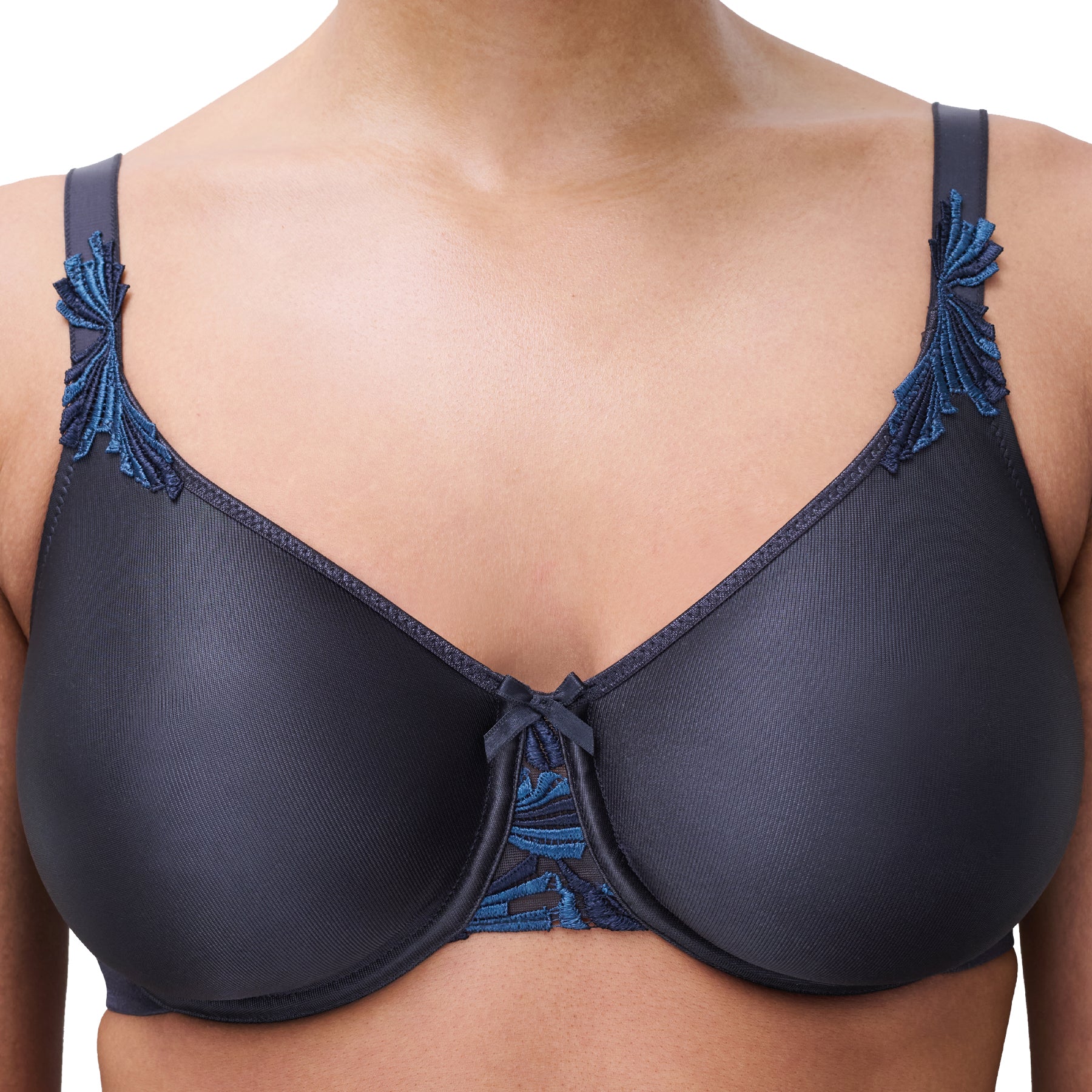 Close-up of Chantelle Hedona bra in deep navy highlighting seamless cups, full support, and embroidered detailing at the straps and centre gore.