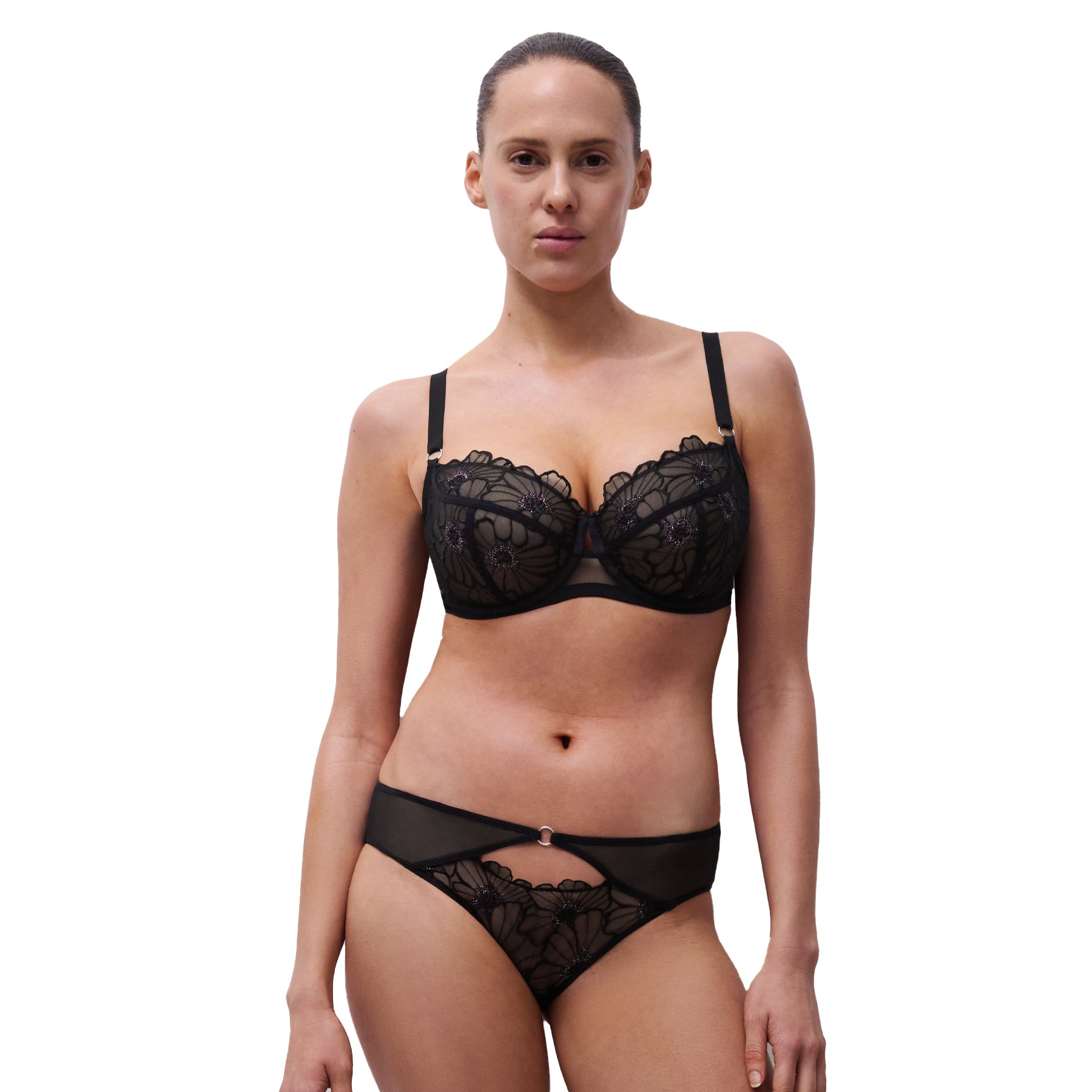 Full-body front view of model wearing black floral embroidered plunge bra and matching bikini brief with cut-out detail.