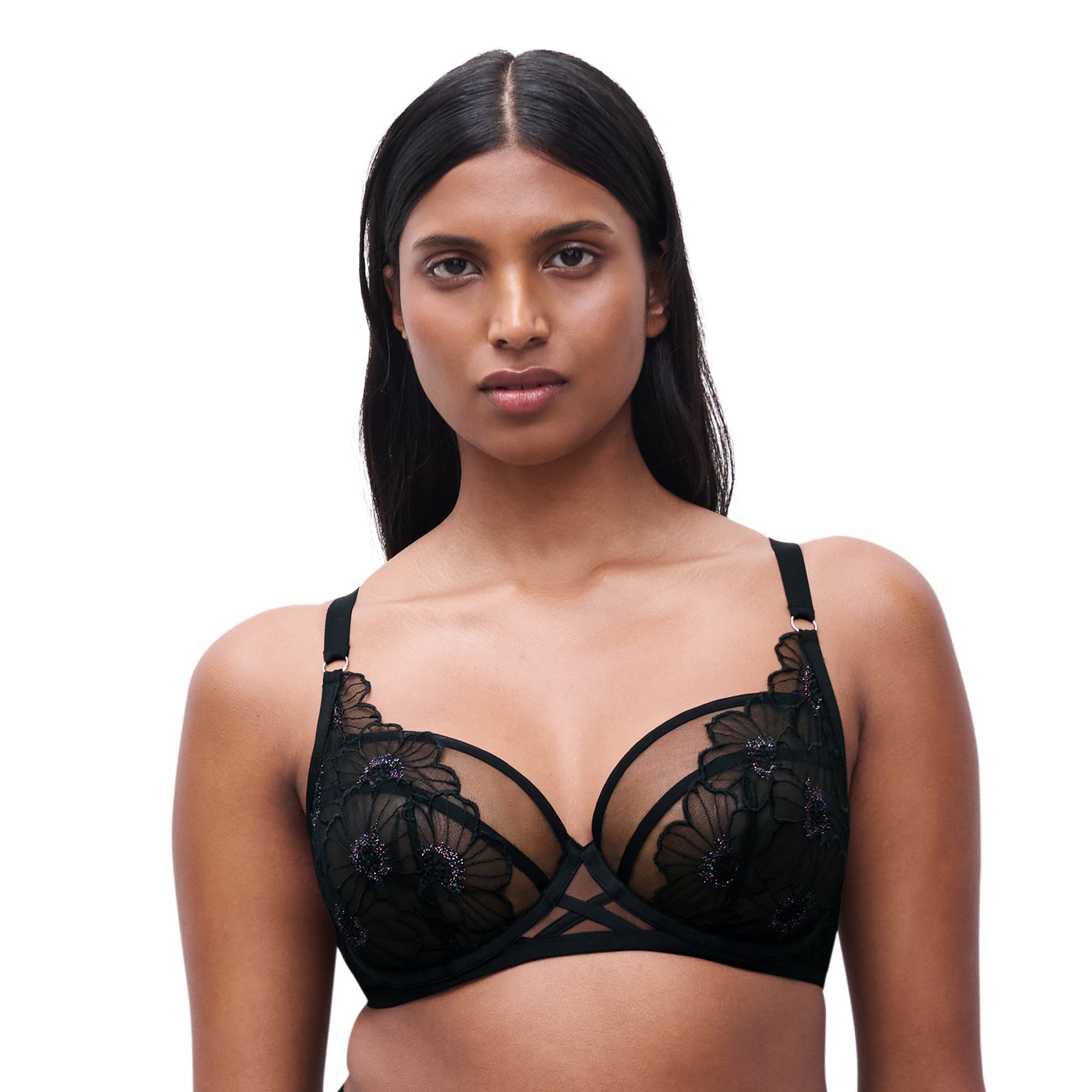 Front view of model wearing black floral embroidered plunge bra with sheer mesh cups and strappy detail at the centre.