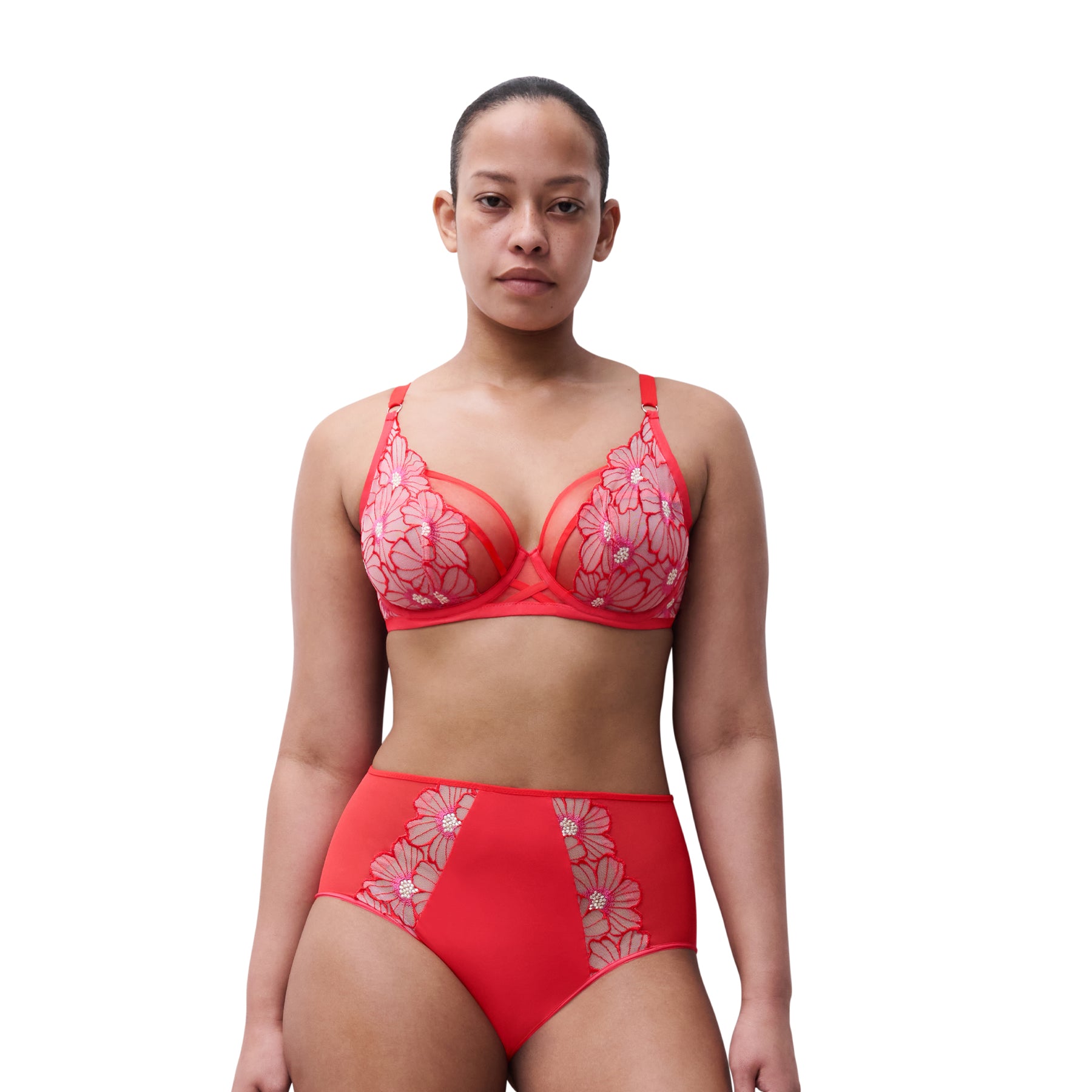 Woman wearing a red floral lingerie set on a white background
