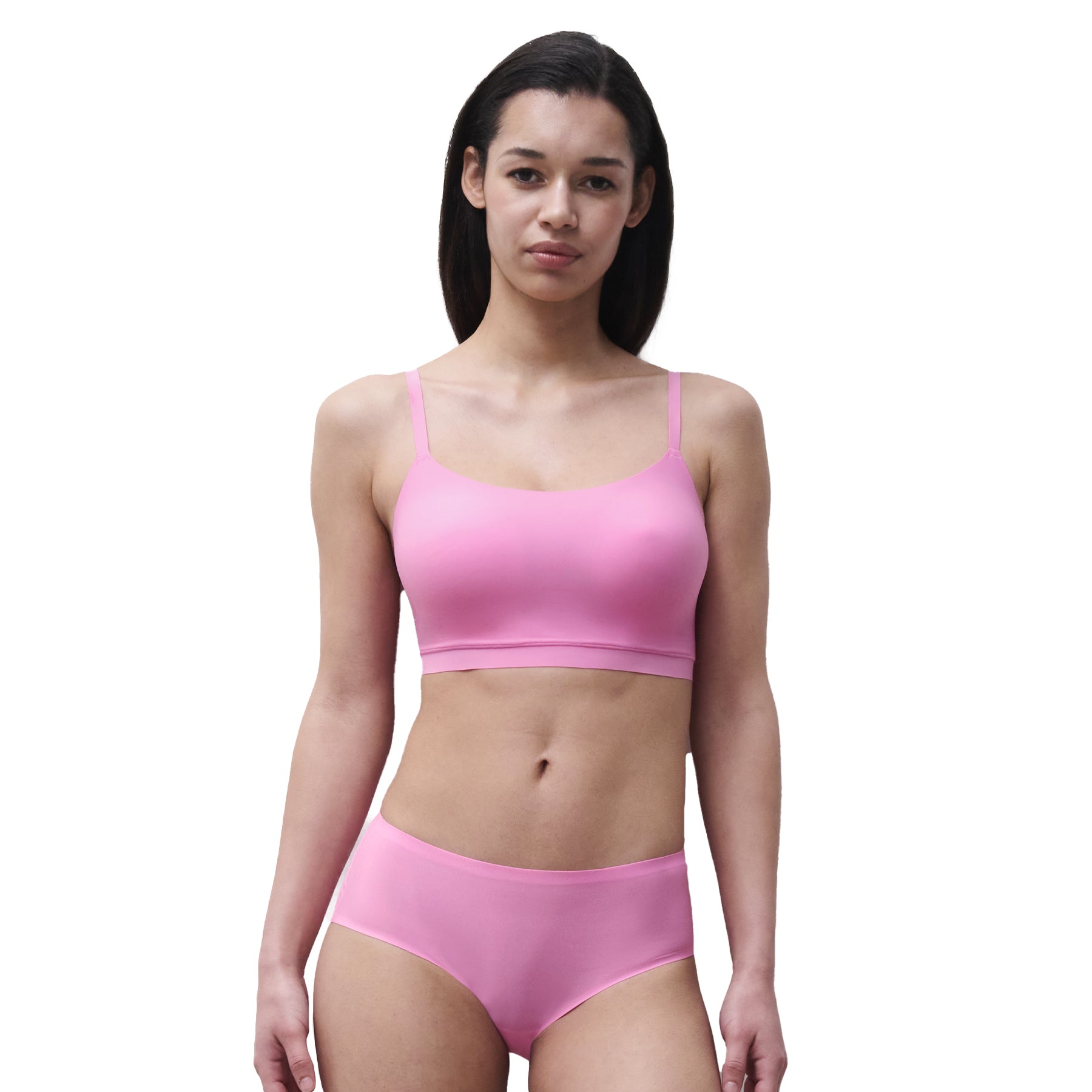 Model wearing a peony pink seamless bikini brief paired with a matching wireless bralette for a clean modern lingerie look.
