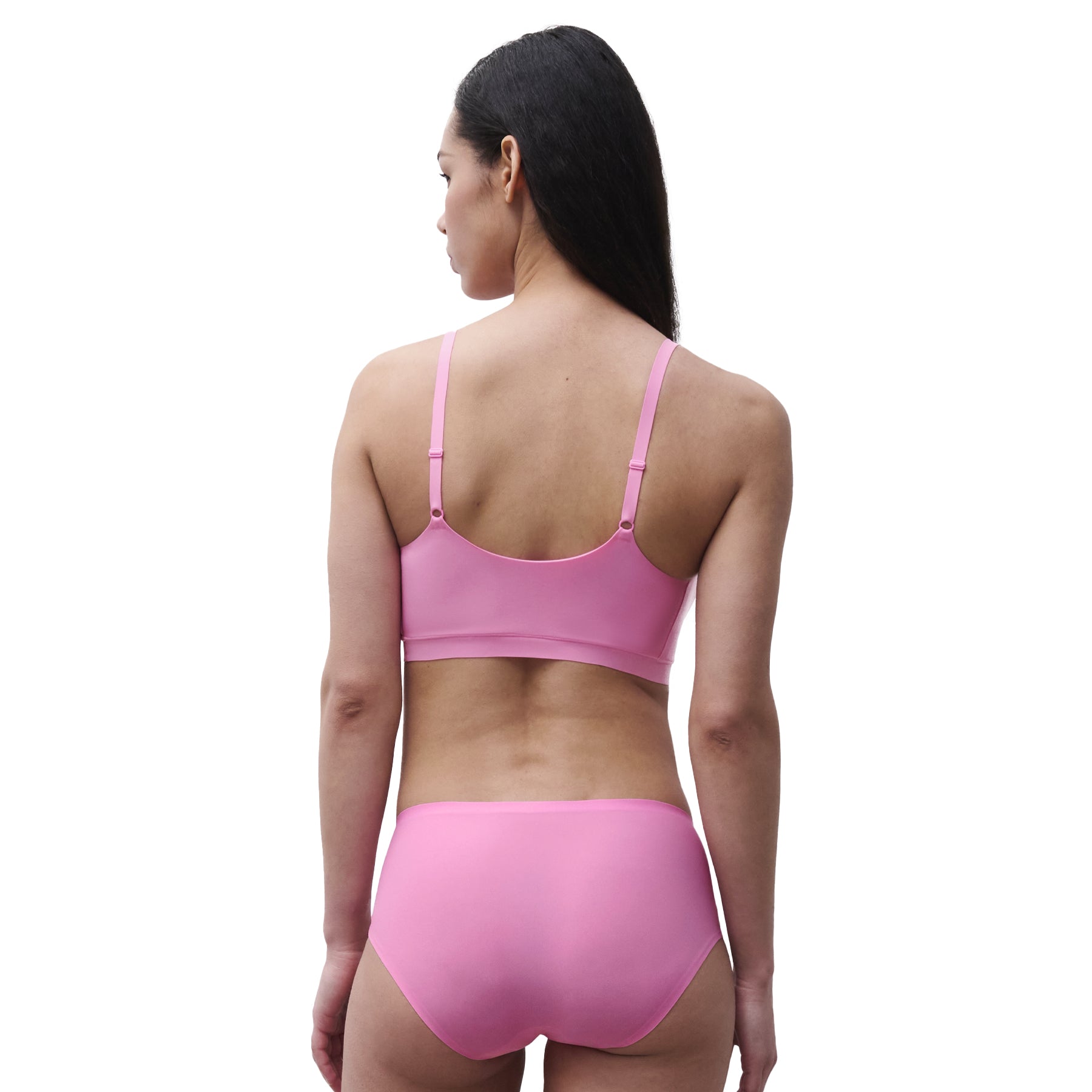 Back view of a peony pink seamless bikini brief with smooth laser-cut edges for a no-show silhouette under clothing.