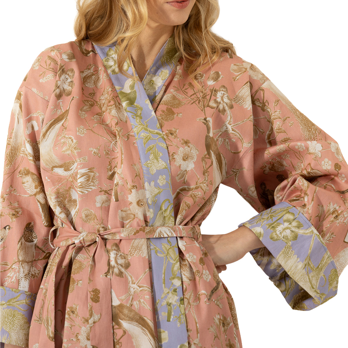 Close-up of dusty pink bird and floral print robe showing lavender contrast trim, wide cuffs and matching fabric belt.
