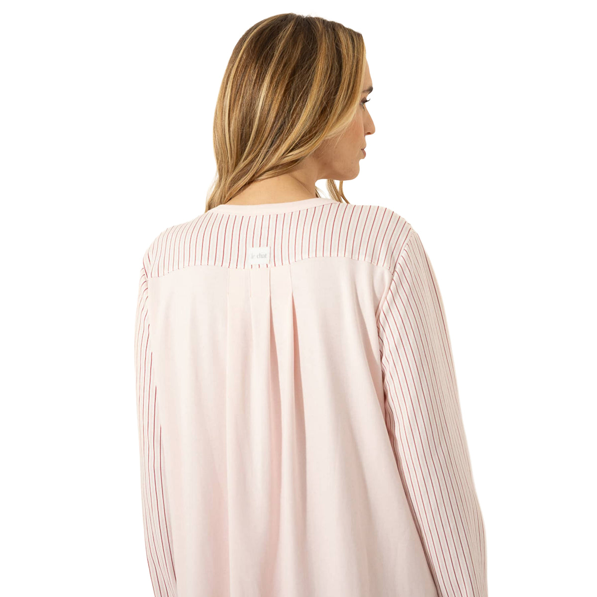 Back detail of a blush pink nightgown featuring striped shoulders, long sleeves and a flowing solid back panel.