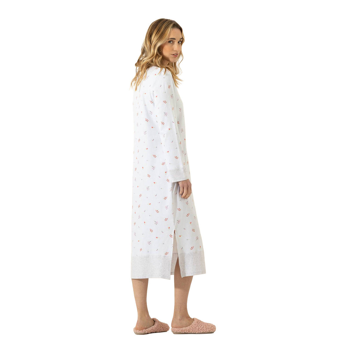 Side view of a long white floral nightgown featuring subtle pinstripes, long sleeves, grey trim, and a side slit.