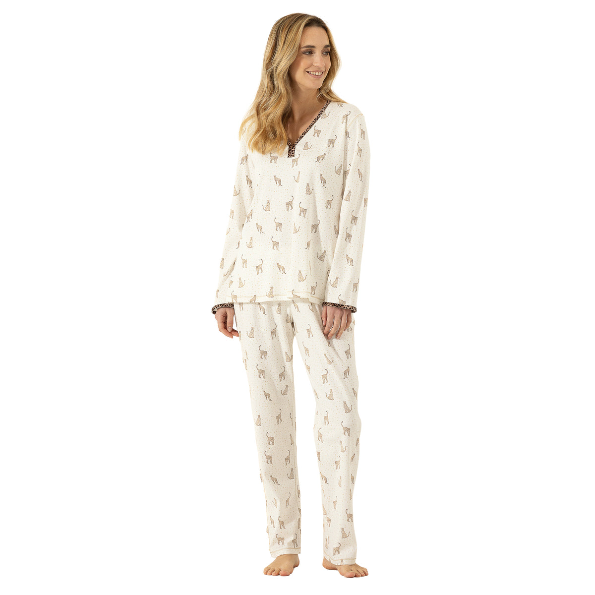 Woman modelling an ivory long-sleeve pajama set with an all-over leopard motif, V-neckline and contrasting leopard-print trim.