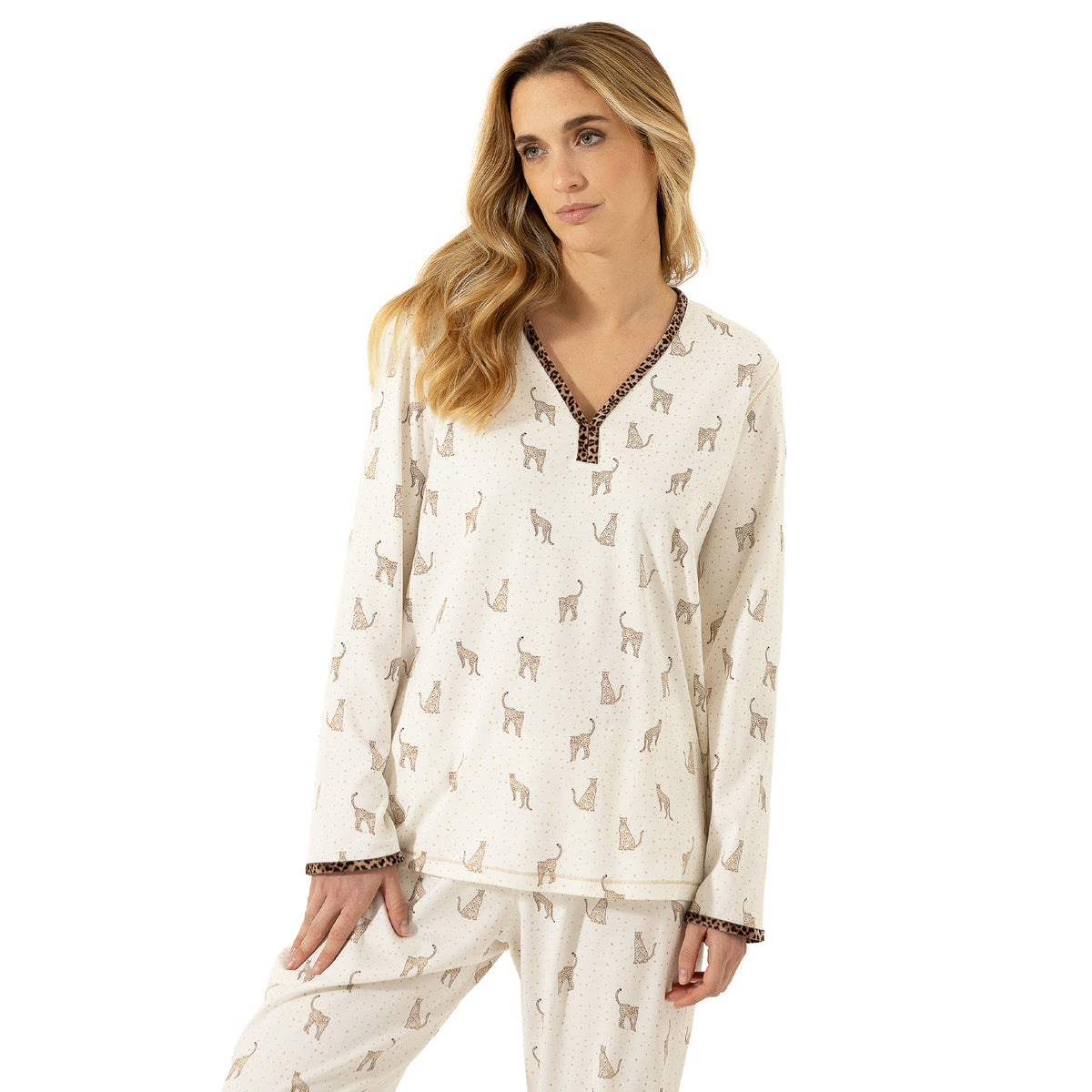Close-up of ivory leopard print pajama set with long sleeves, V-neckline and coordinating animal-print trim at the neckline and cuffs.