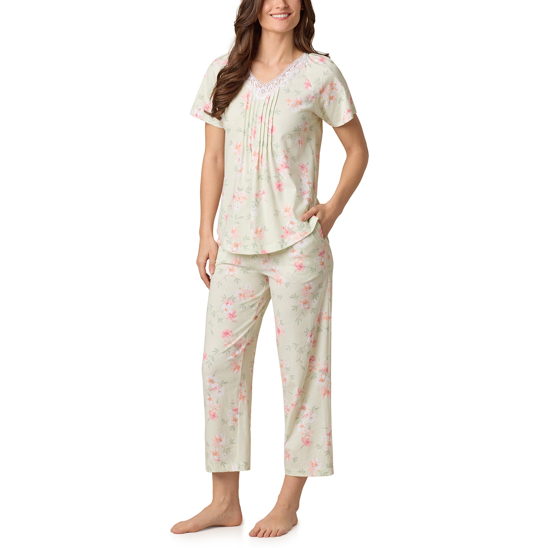 Woman wearing green floral V-neck pajama set with capri pants - front view