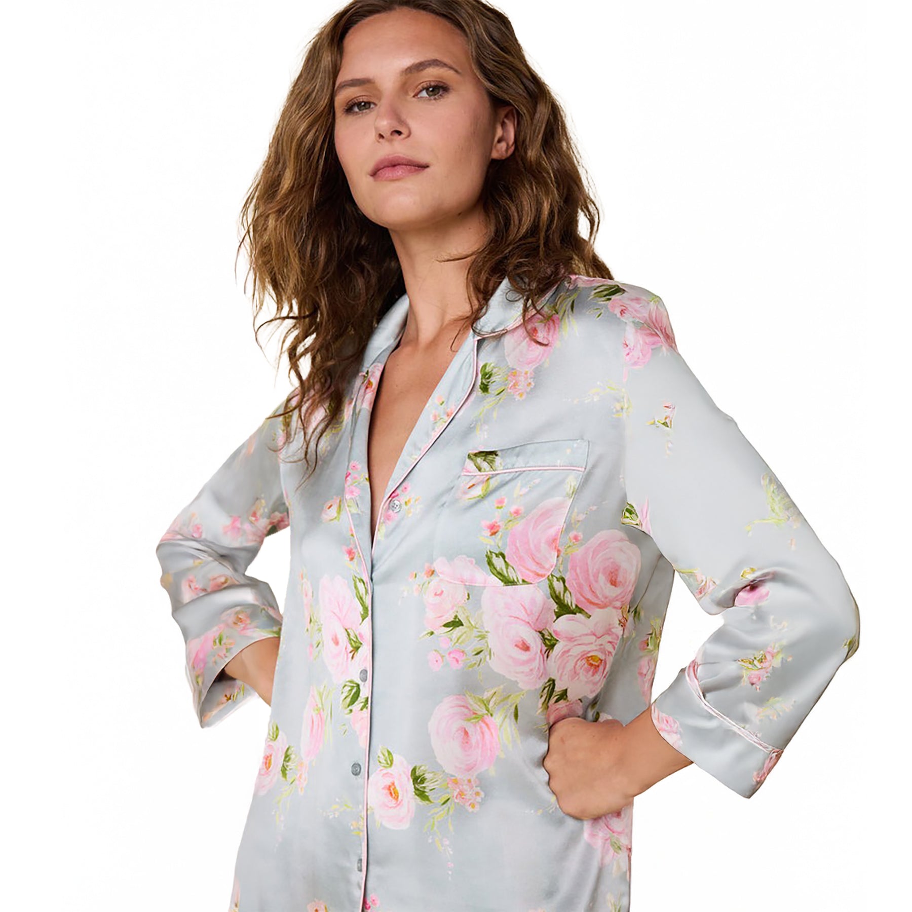 100% silk classic button up pajama set in a multicolour floral print on a light blue background. Front view on model closeup.