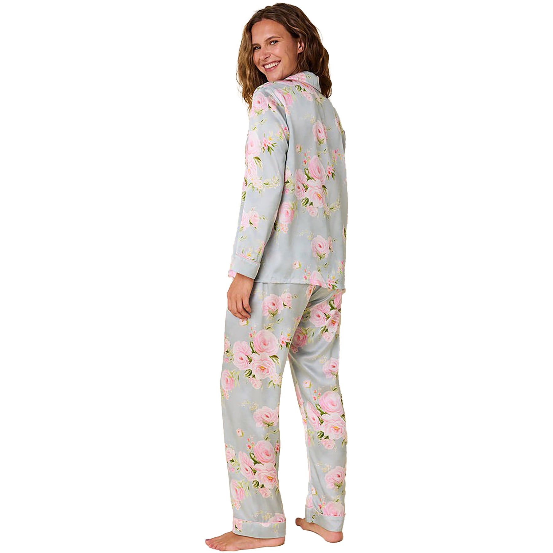 100% silk classic button up pajama set in a multicolour floral print on a light blue background. Rear view on model.