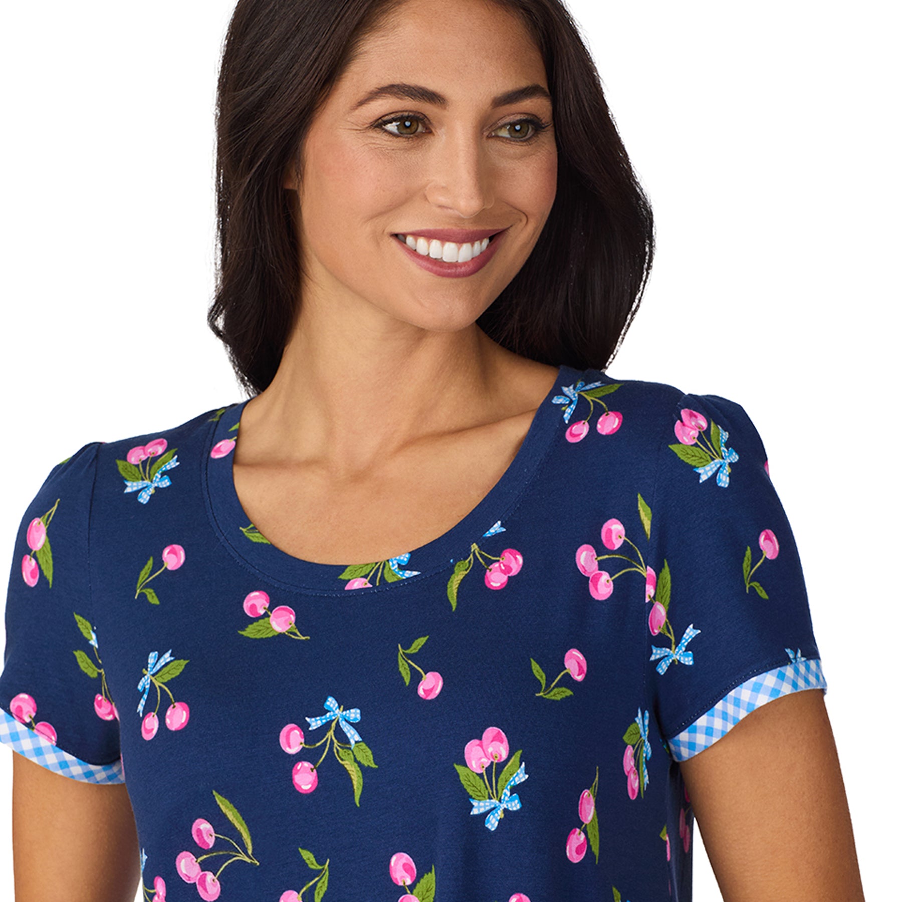 Close-up of neckline and sleeve of navy nightgown with cherry motif and gingham trim
