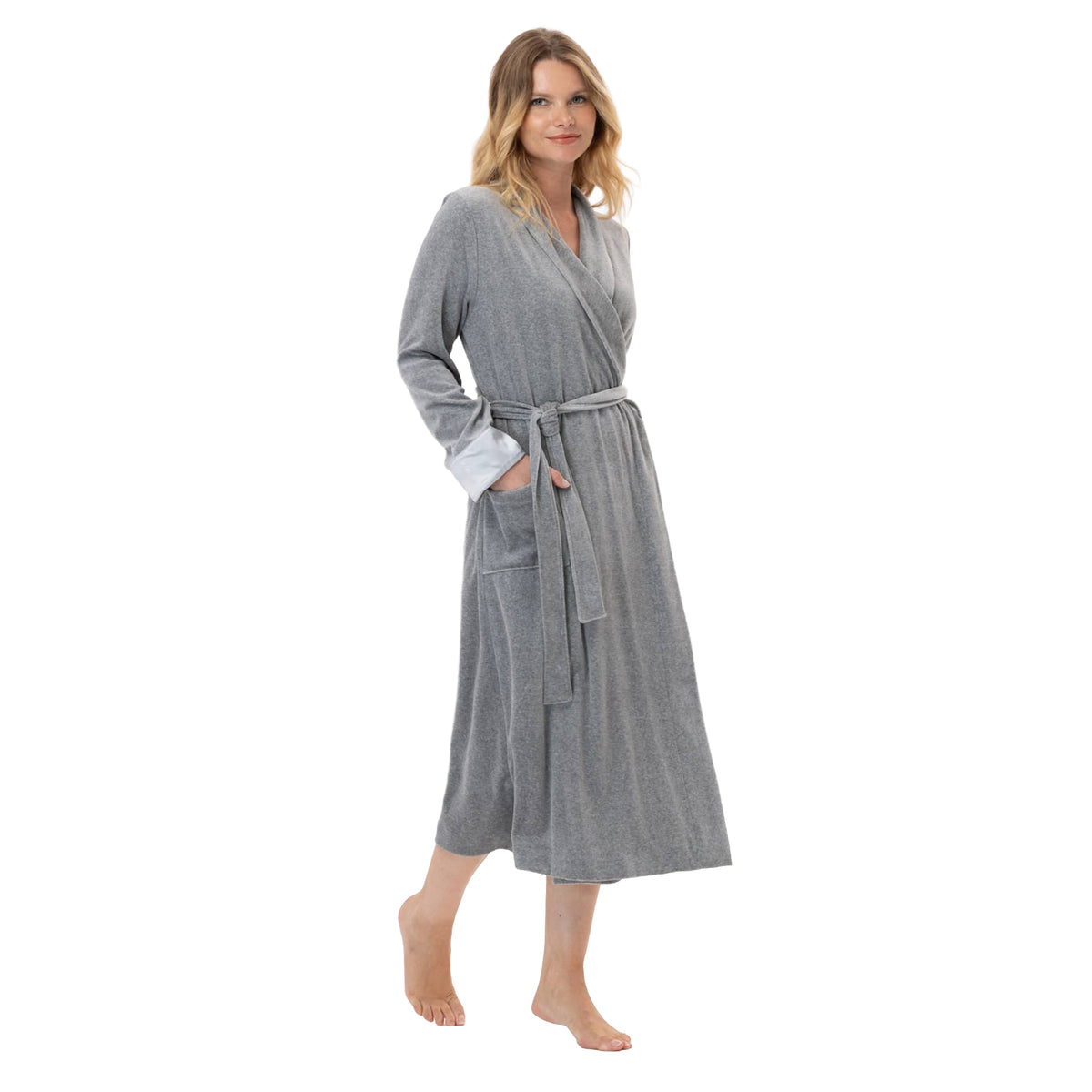 Woman wearing a long grey velour wrap robe with a shawl collar, tie waist, satin cuffs, and front patch pockets.