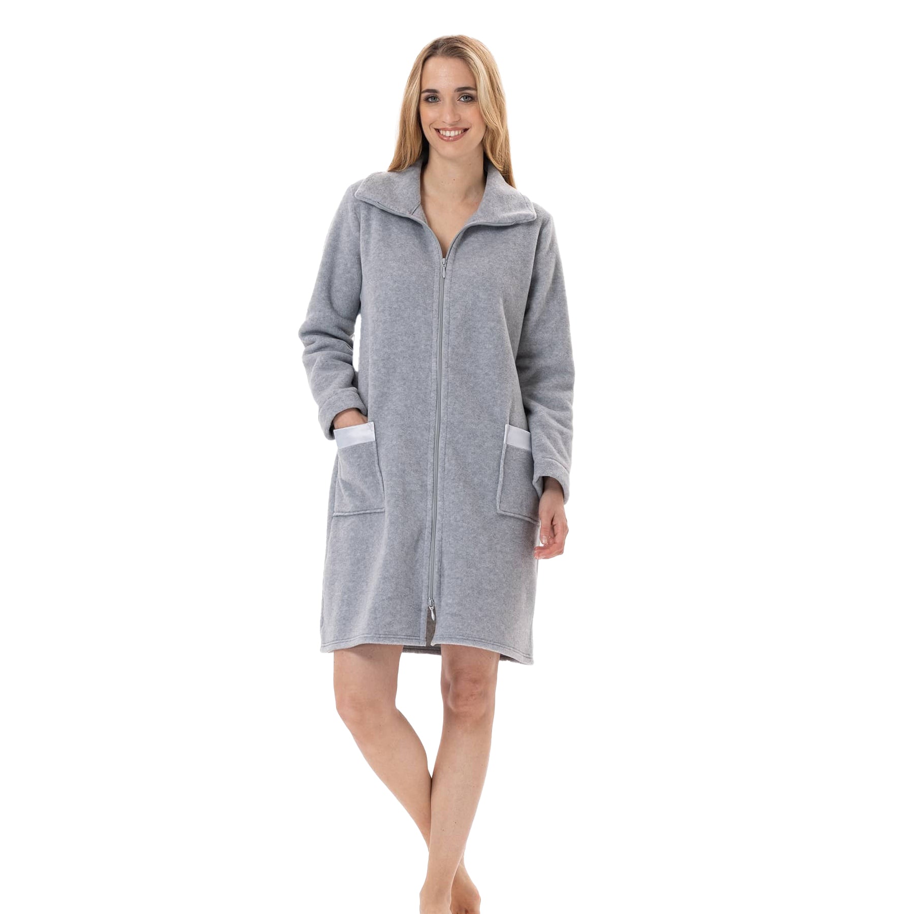 Woman wearing a light grey fleece zip-up robe with front pockets and collar, smiling with hands in pockets.