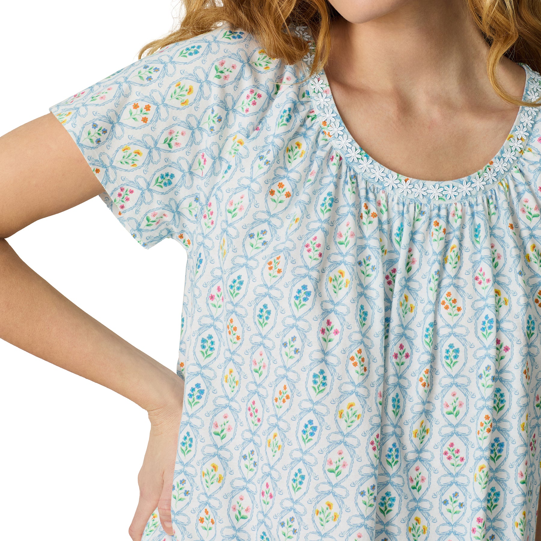 Close-up of Carole Hochman ivory short sleeve nightgown with blue floral wallpaper print and delicate lace-trim neckline