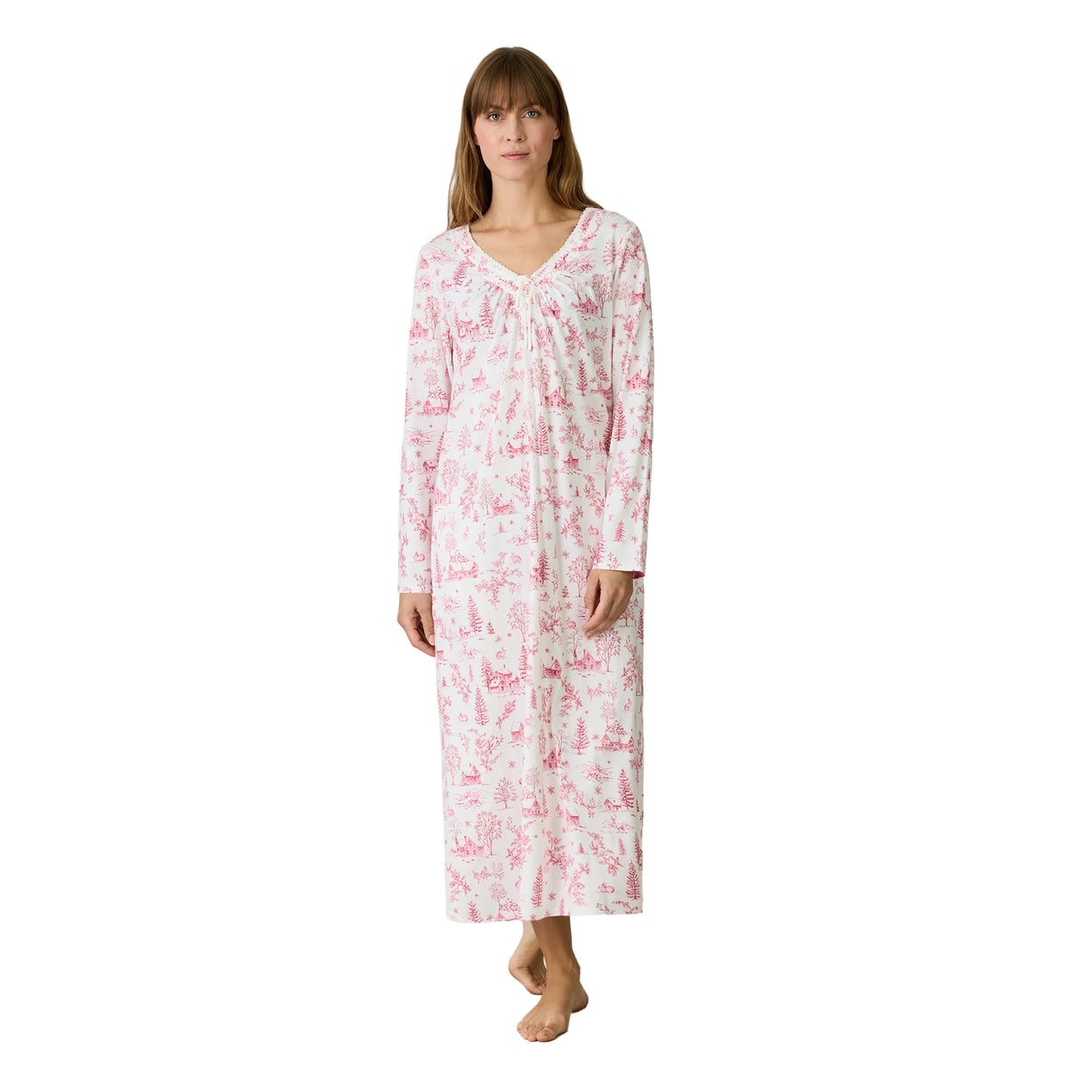 Front view of a Carole Hochman white long-sleeve nightgown featuring pink woodland scenes, winter cottages, trees and a delicate lace-trimmed neckline with a tie detail.