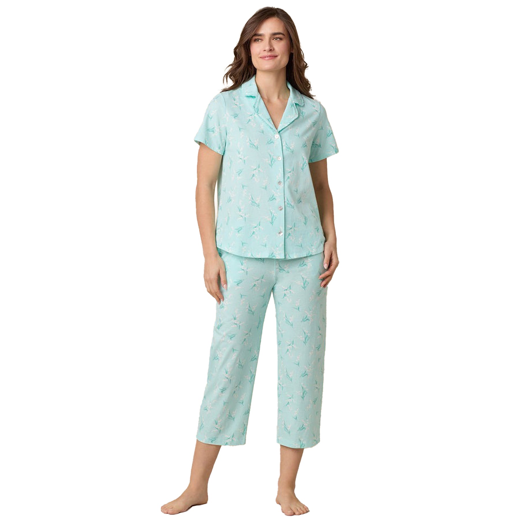 Woman wearing mint green floral cotton pyjama set with short sleeves and button-up top - front view.