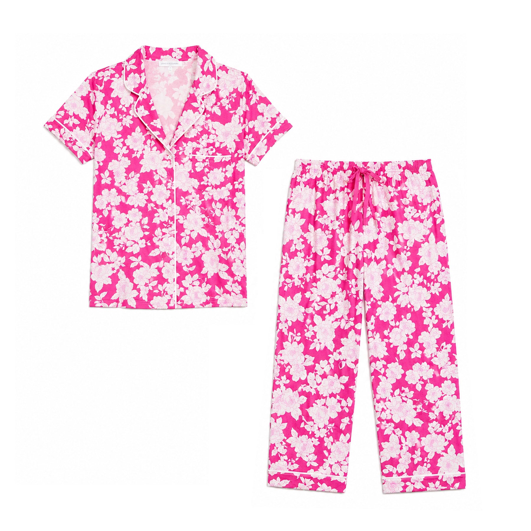 Flat lay of Carole Hochman pink floral pyjama set with button front top and matching capri pants on white background