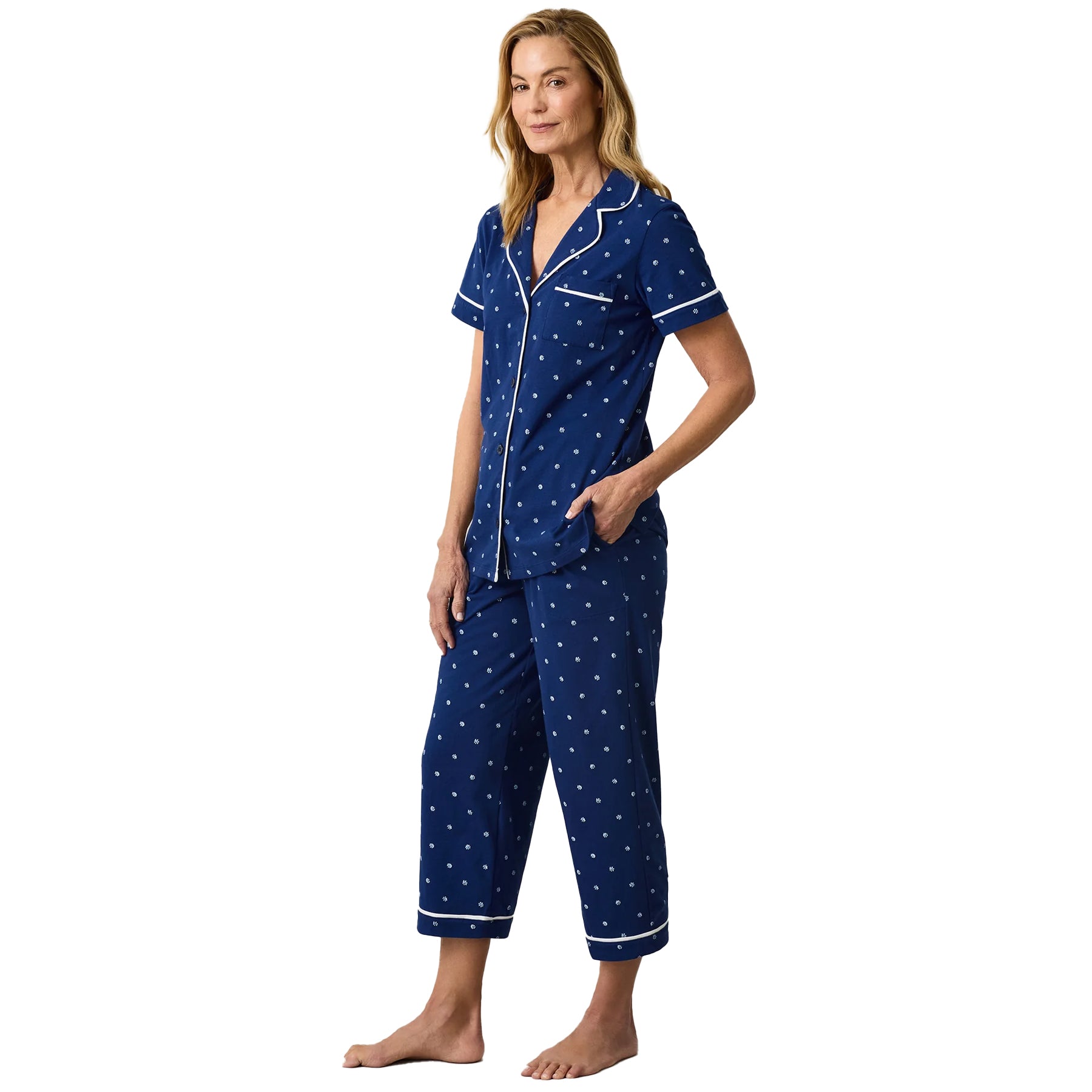 Navy blue floral pyjama set with short sleeve button-down top, contrast piping and relaxed cropped pants.