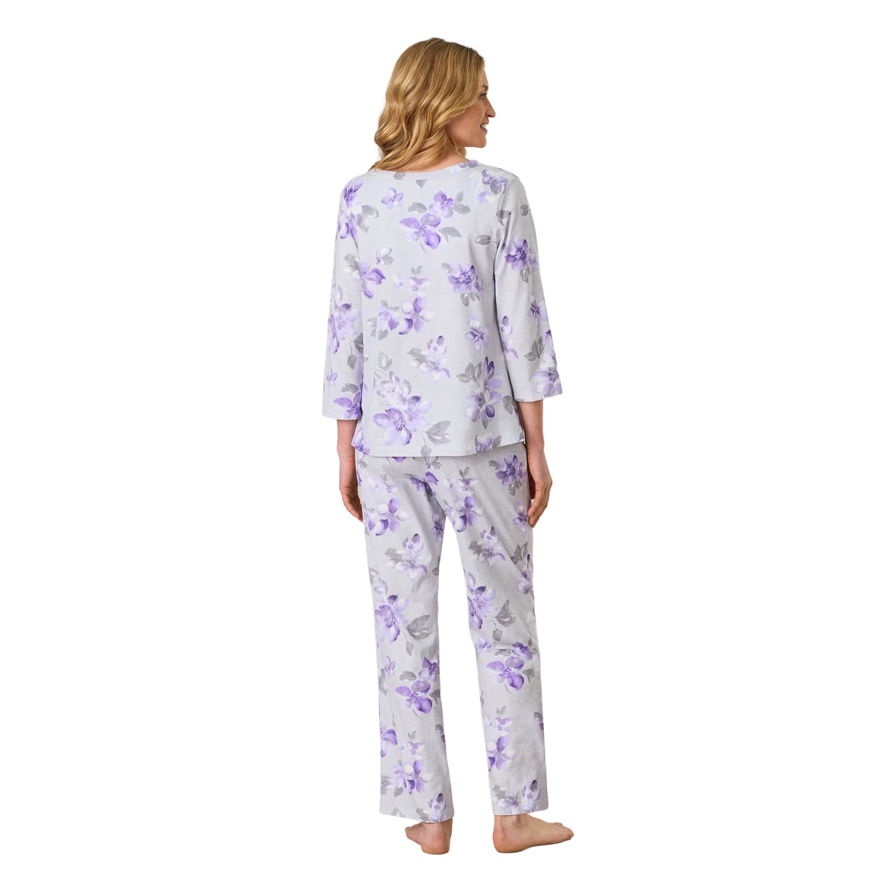 Back view of the women’s grey pajama set with an all-over purple floral print, three-quarter sleeves and relaxed straight-leg pants