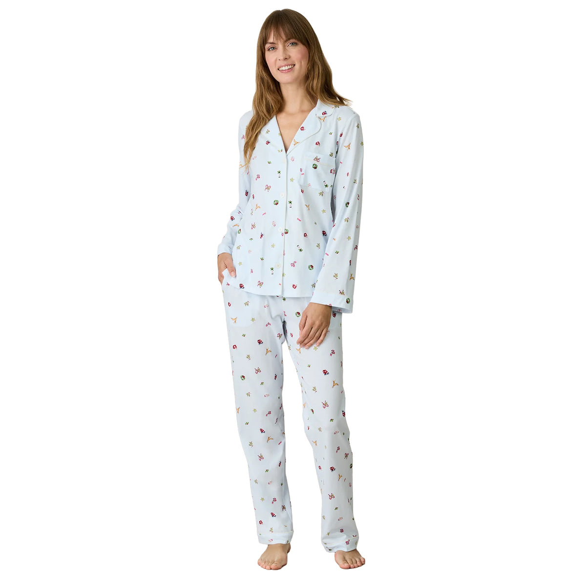 Carole Hochman light blue holiday pajama set featuring a long-sleeve button-down top with notched collar, chest pocket, white piping and matching full-length pants with festive Christmas prints.