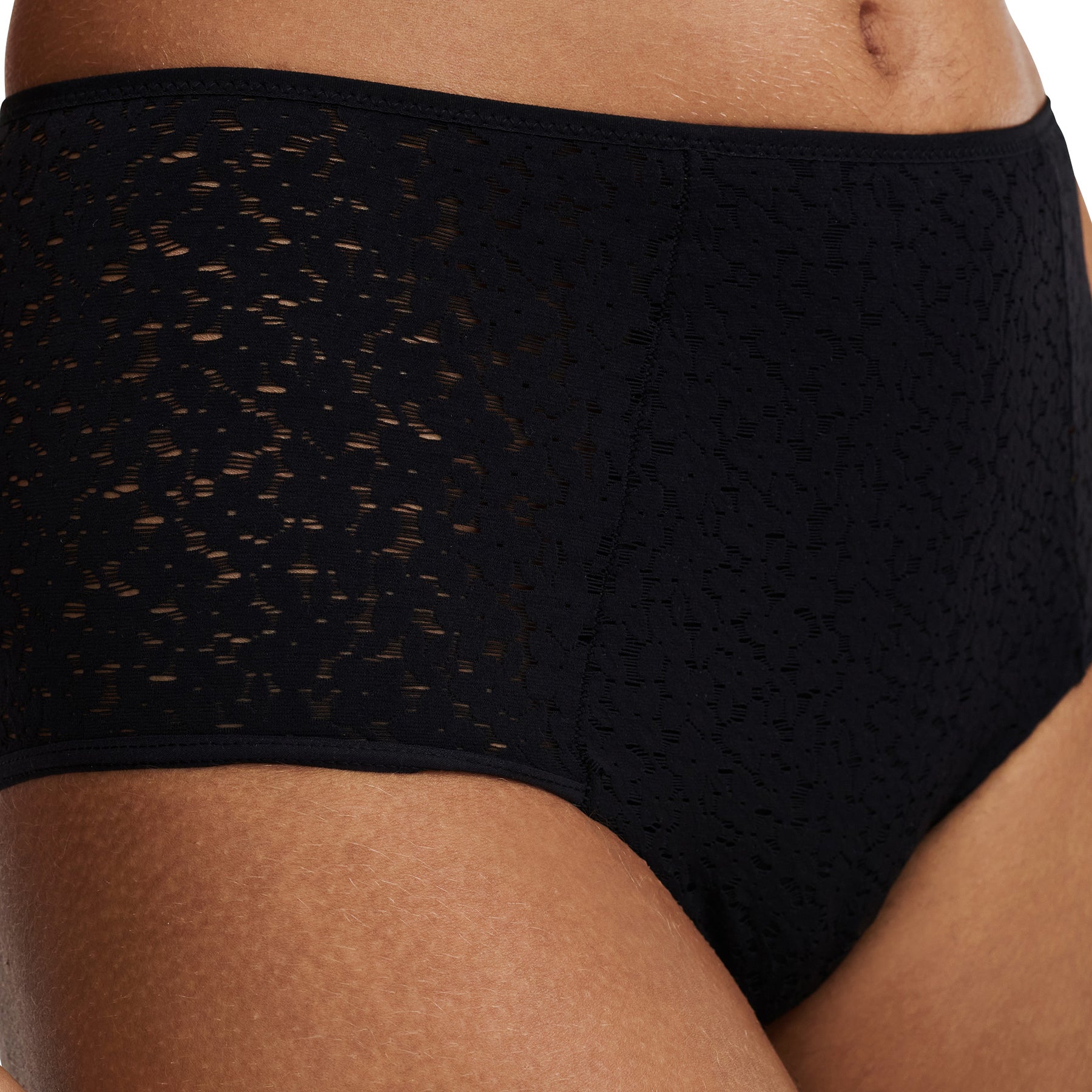 Chantelle light control Norah full brief with floral lace in black. Side view close up on model.