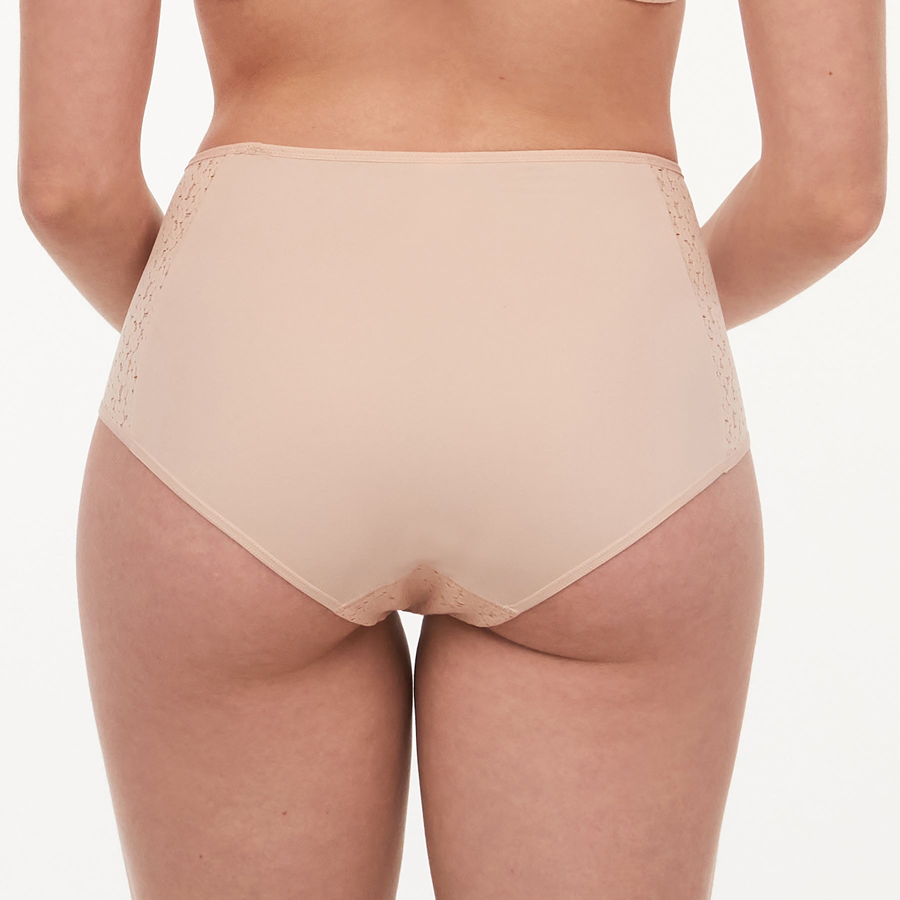 Chantelle light control Norah full brief with floral lace in nude golden beige. Rear view on model.