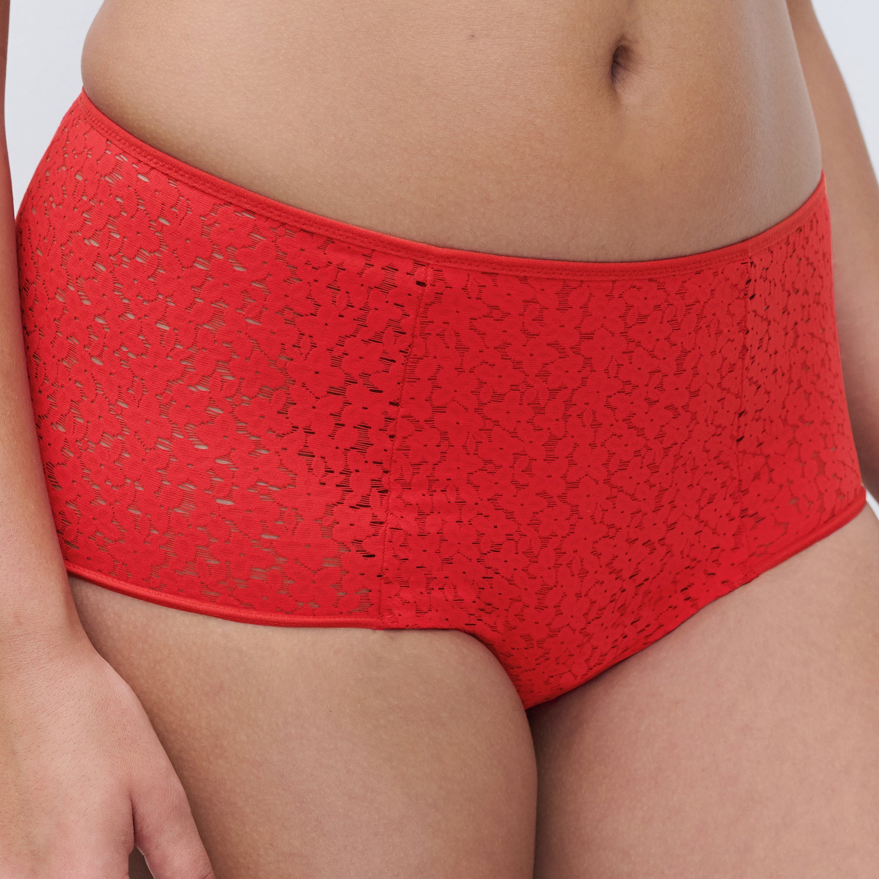 Chantelle light control Norah full brief C13F3 with floral lace in poppy red 0YU. Front view close up on model.